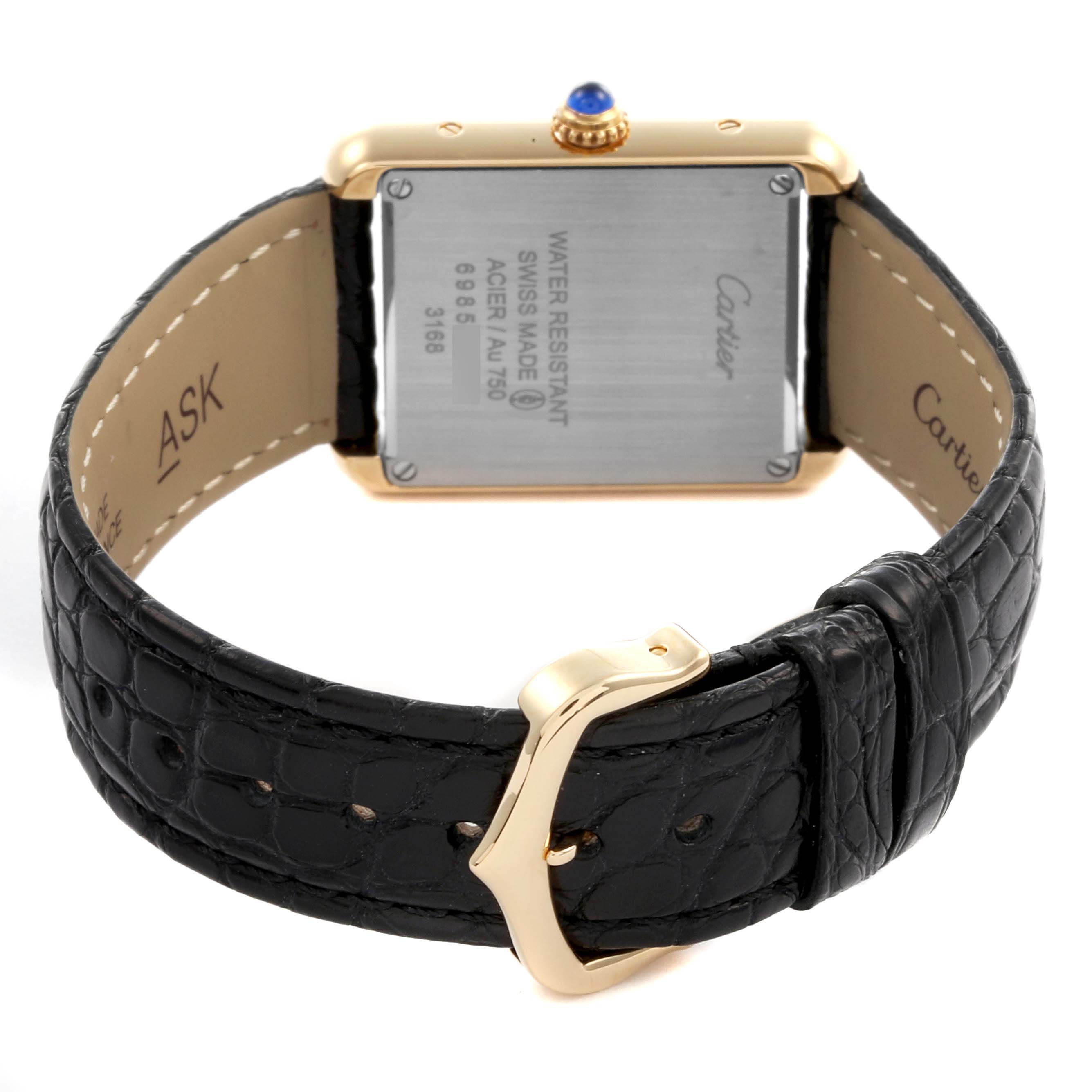 The Cartier Tank Solo W5200002 Women's Steel and Gold (two tone) Silver Dial W5200002 Women's Steel and Gold (two tone) Silver Dial watch is shown from the back, highlighting the case back and black leather strap with a buckle.