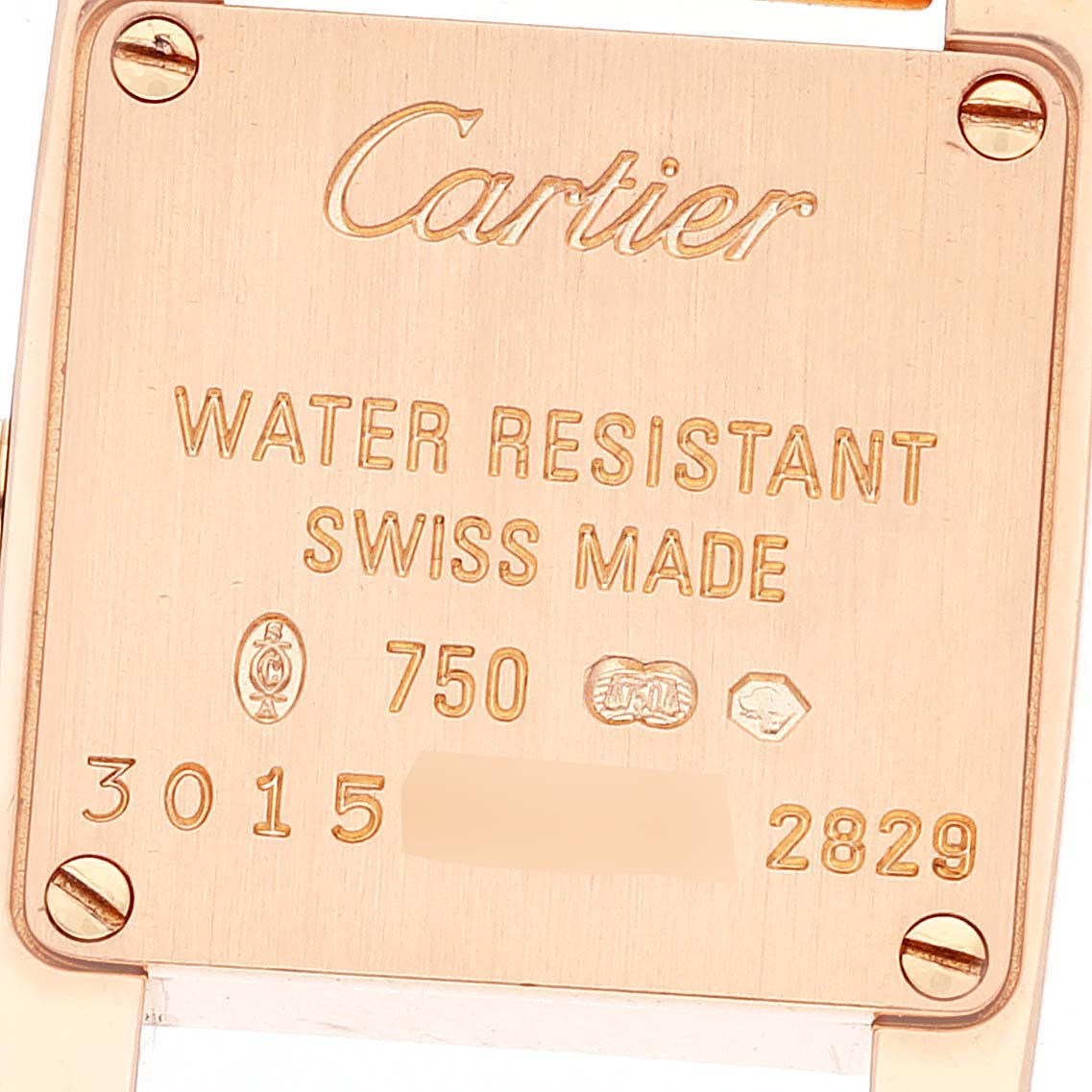 The image shows the back case of a Tankissime model watch by Cartier, featuring engravings with branding and specifications.