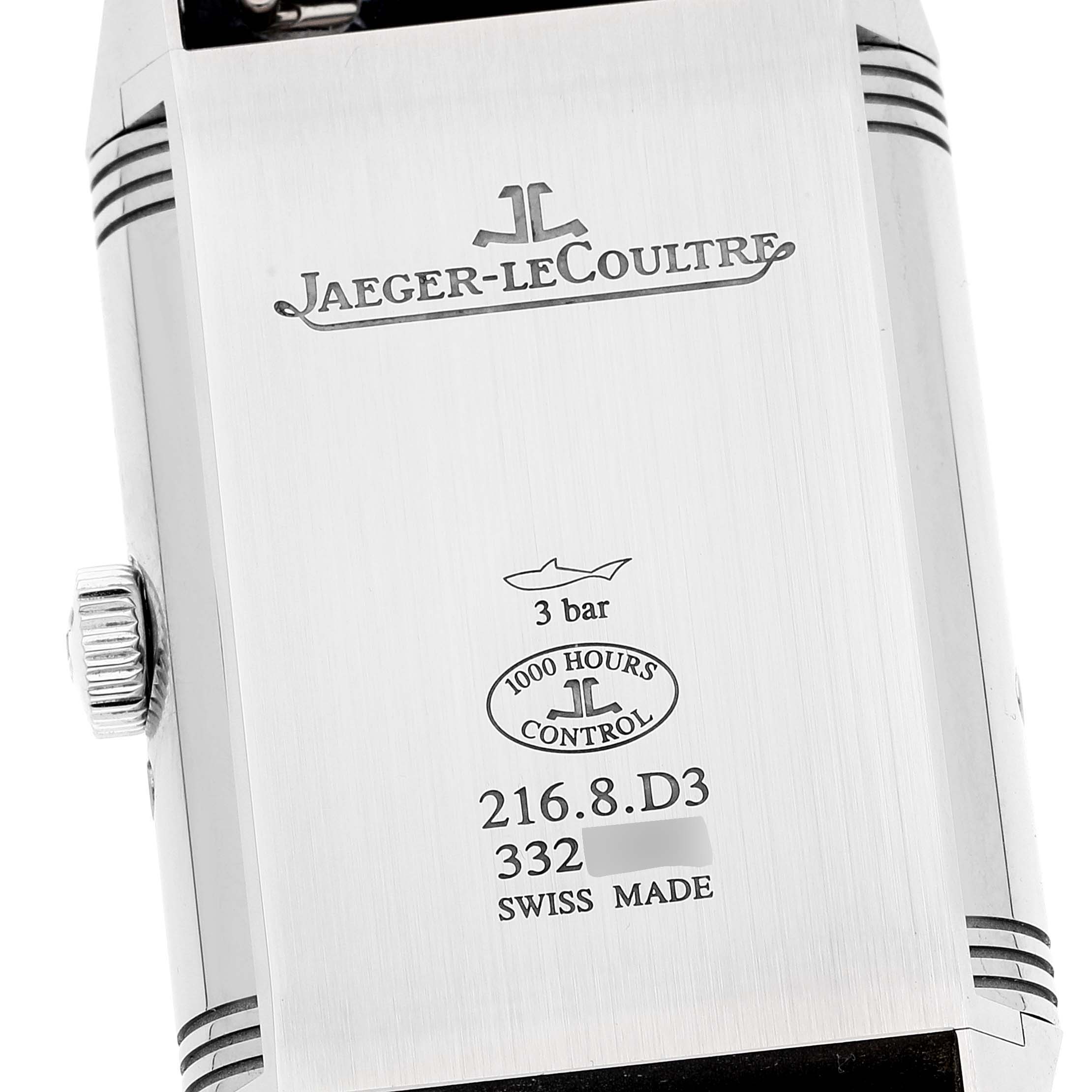 The image shows the case back of a Jaeger-LeCoultre Reverso watch, displaying brand engravings and specifications.