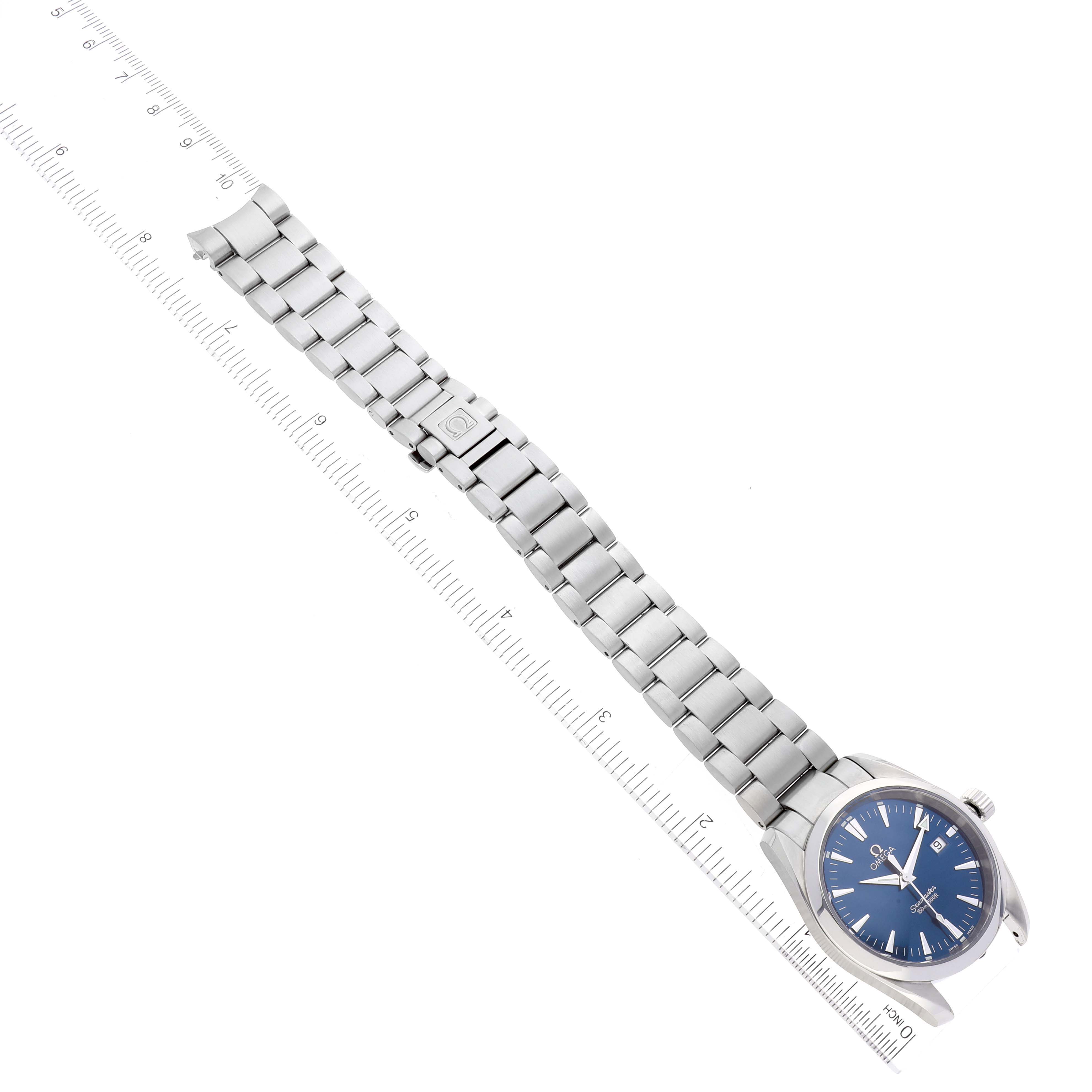 The Omega Aqua Terra 2517.80.00 Men's Stainless Steel Blue Dial 2517.80.00 Men's Stainless Steel Blue Dial watch is shown from a top-down angle, displaying its blue dial and metal bracelet alongside a ruler.
