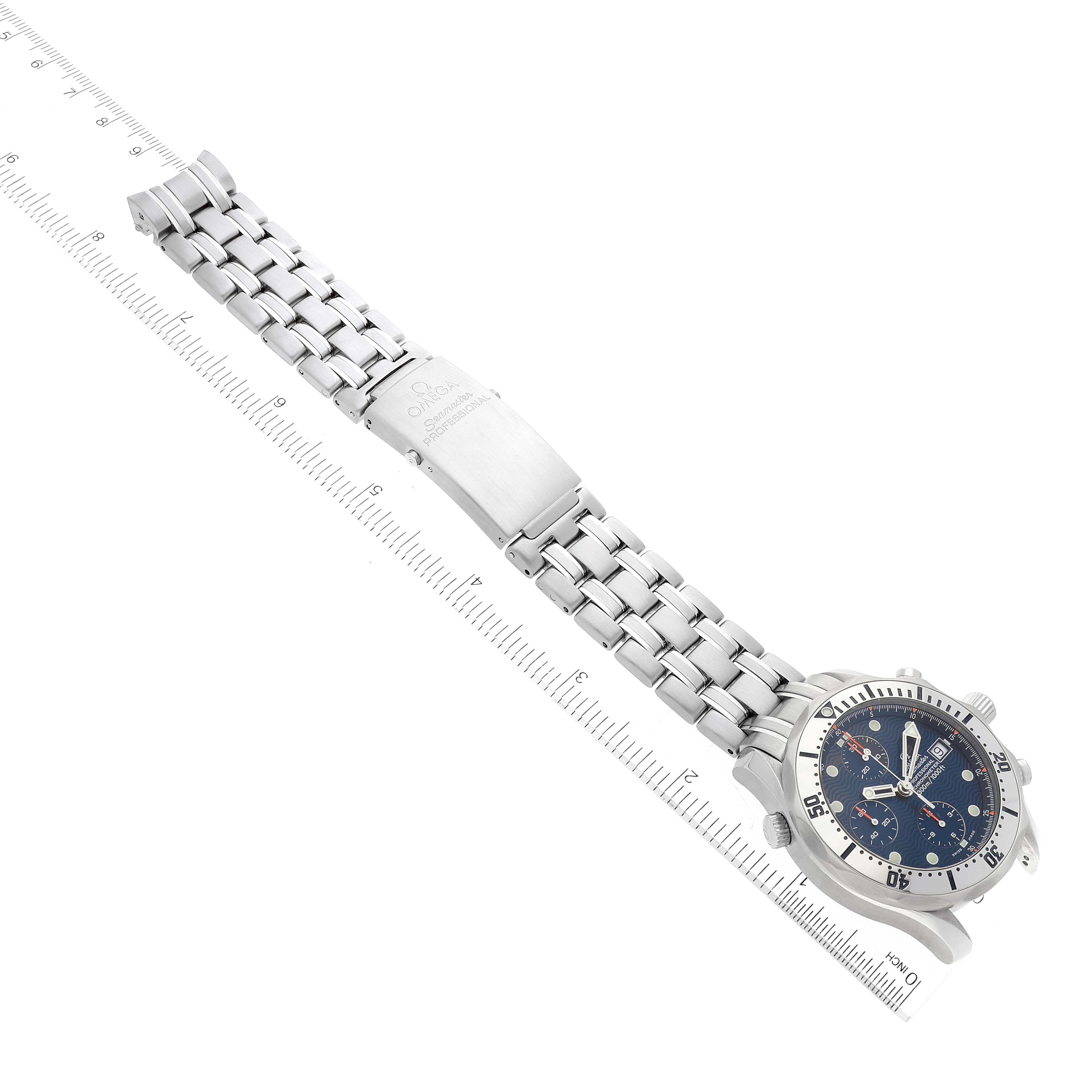The image shows the full length of the Omega Seamaster 2598.80.00 Men's Stainless Steel Blue Dial 2598.80.00 Men's Stainless Steel Blue Dial watch, including its face, bezel, and bracelet, placed on a measuring ruler.