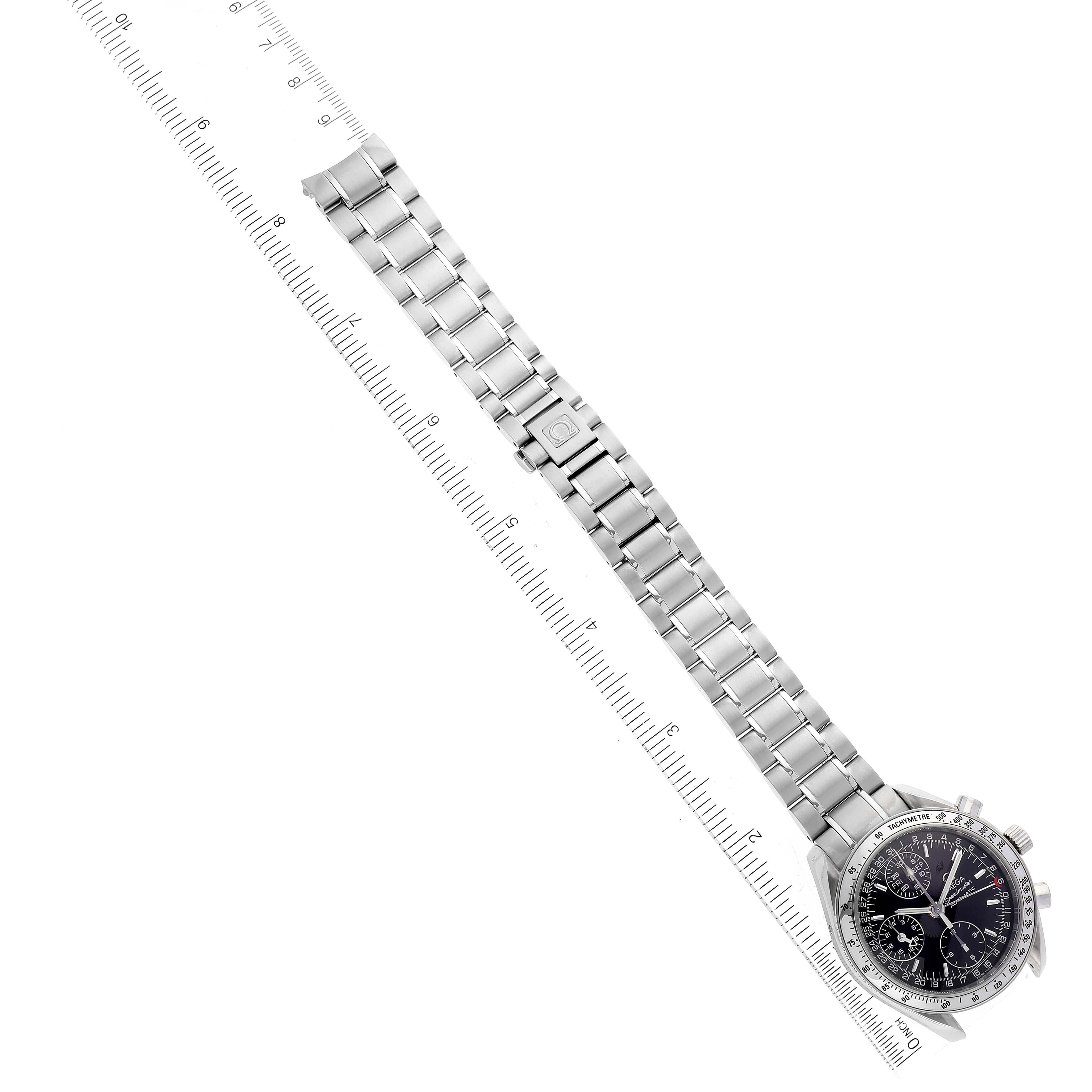 The image shows an Omega Speedmaster 3523.50.00 Men's Stainless Steel Black Dial 3523.50.00 Men's Stainless Steel Black Dial watch laid flat with its stainless steel bracelet extended and aligned with a measuring ruler.