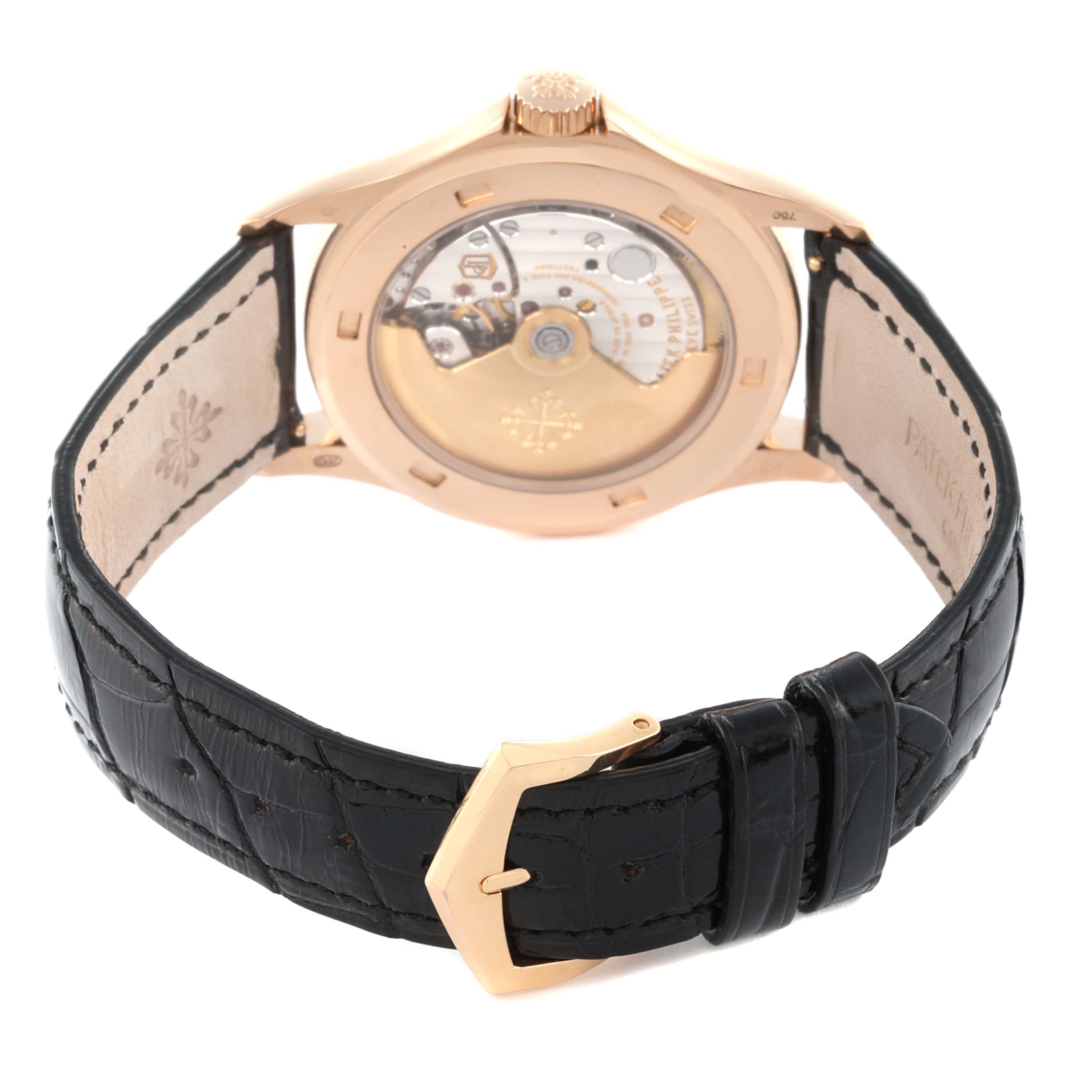 The Patek Philippe Calatrava 5127R-001 Men's Rose Gold Silver Dial 5127R-001 Men's Rose Gold Silver Dial watch is shown from the rear angle, displaying the open case back and leather strap.