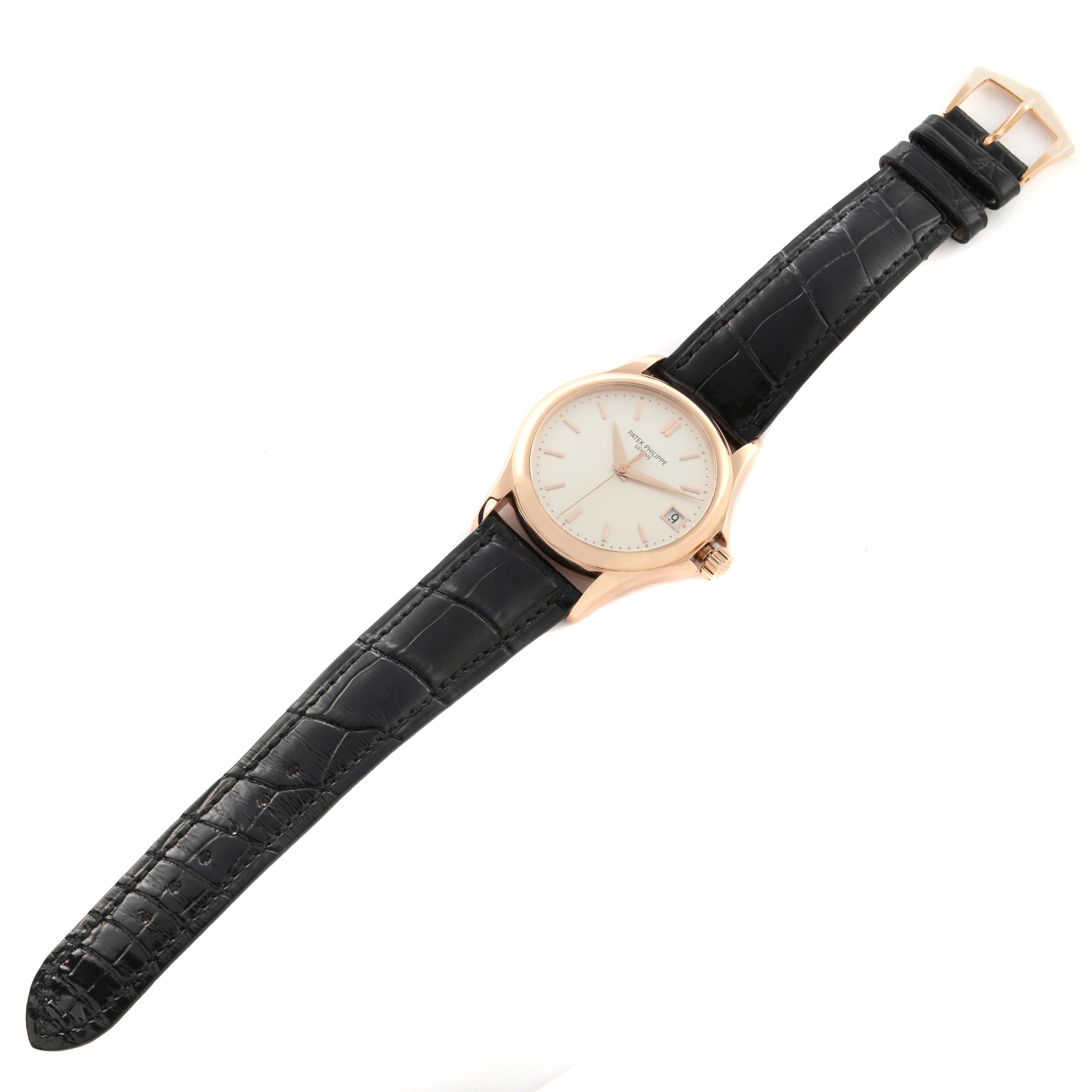 The Patek Philippe Calatrava 5127R-001 Men's Rose Gold Silver Dial 5127R-001 Men's Rose Gold Silver Dial watch is shown from a top-angle view, displaying the face and entire leather strap.