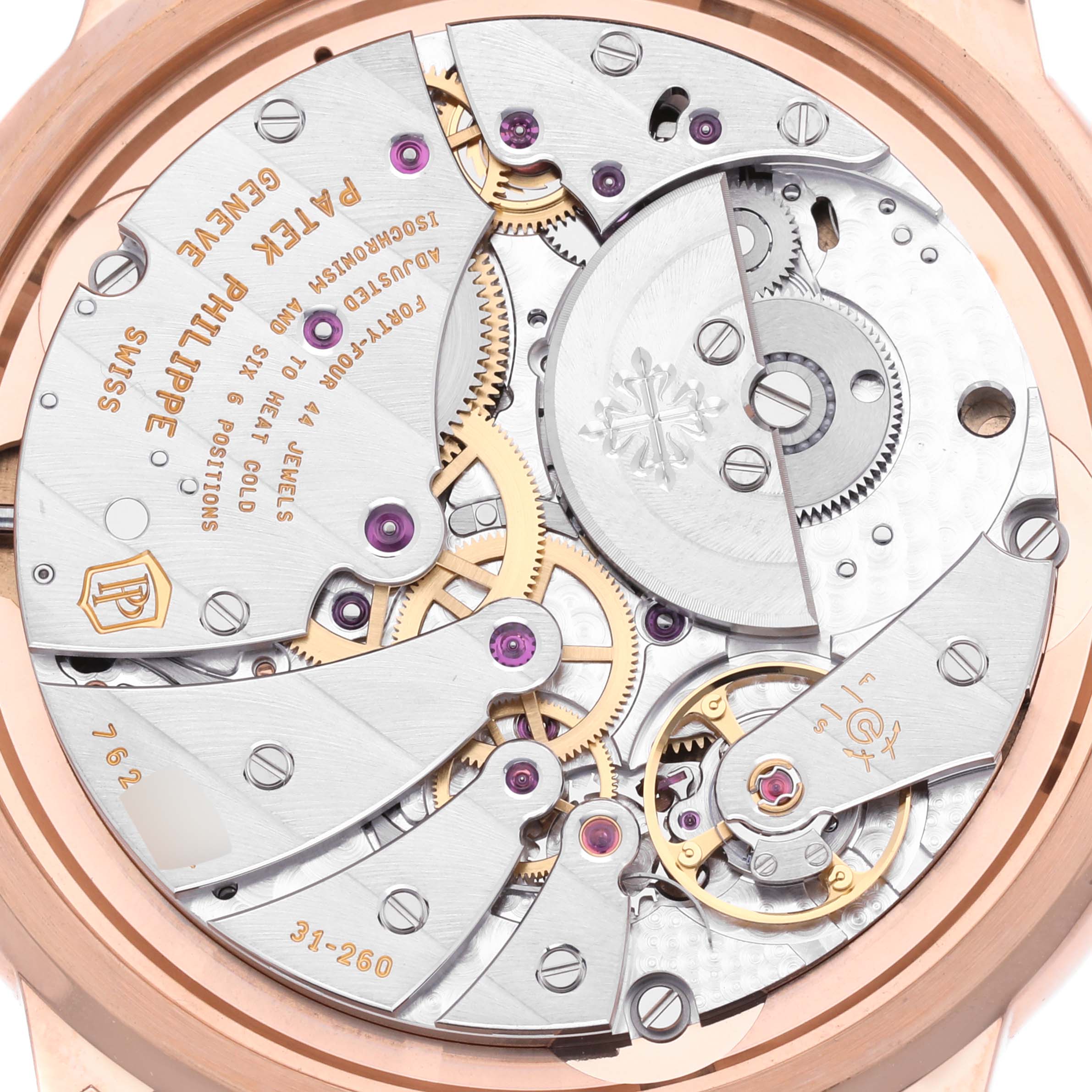 The image shows the movement of the Patek Philippe Calatrava 5224R-001 Men
s Rose Gold Blue Dial 5224R-001 Men
s Rose Gold Blue Dial model from a backside angle, highlighting gears and jewels.
