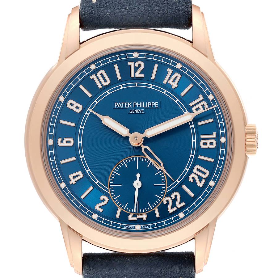 The Patek Philippe Calatrava watch is shown from the front, displaying its blue dial and gold numerals.