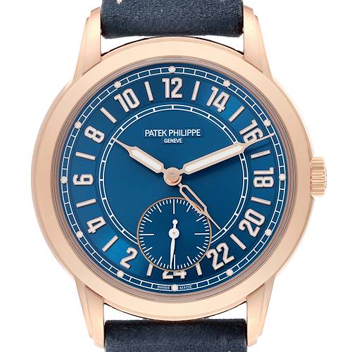 The Patek Philippe Calatrava watch is shown from the front, featuring its blue dial, rose gold case, and leather strap.