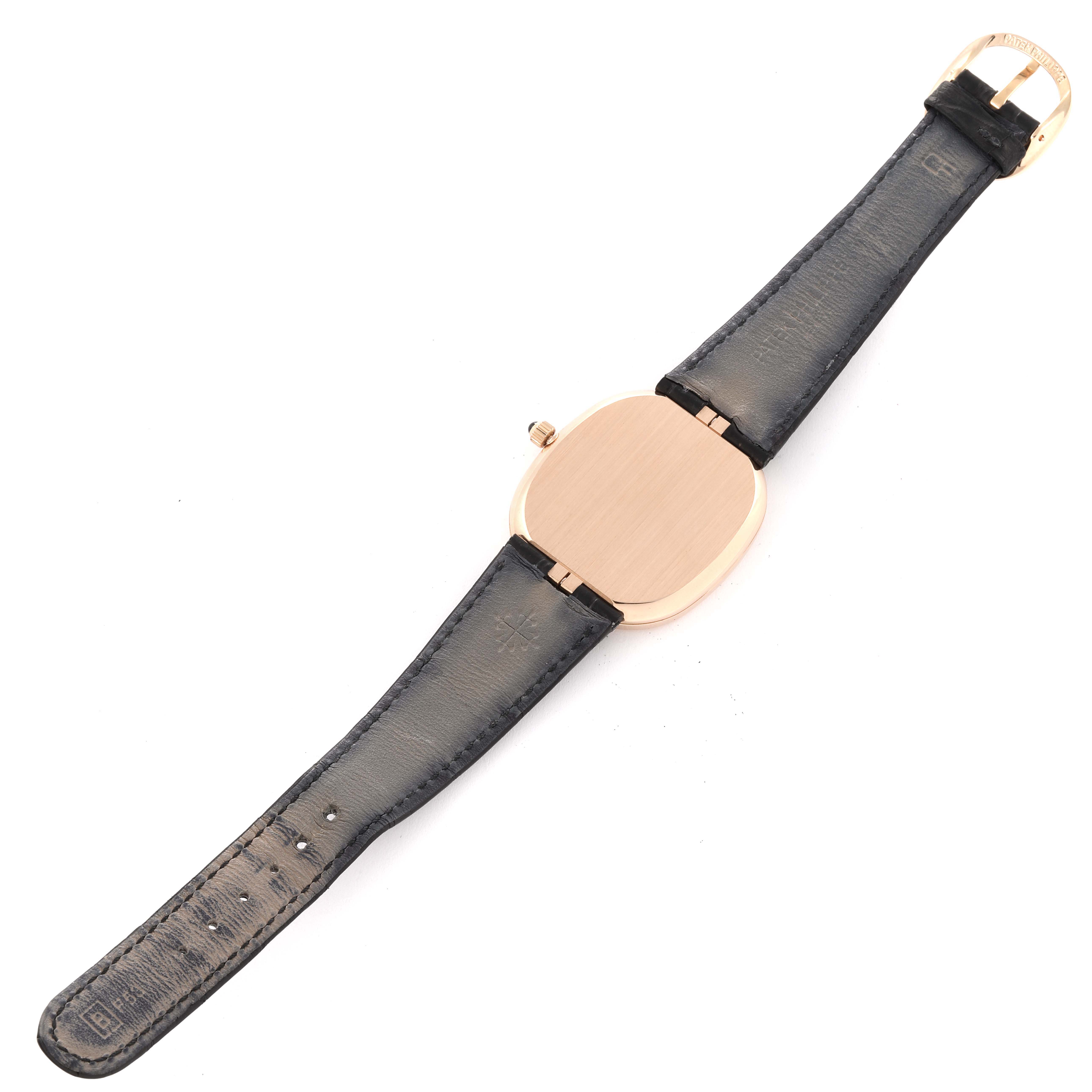 The image shows the back view of the Patek Philippe Golden Ellipse 5738R-001 Men's Rose Gold Black Dial 5738R-001 Men's Rose Gold Black Dial watch with its black strap fully extended.