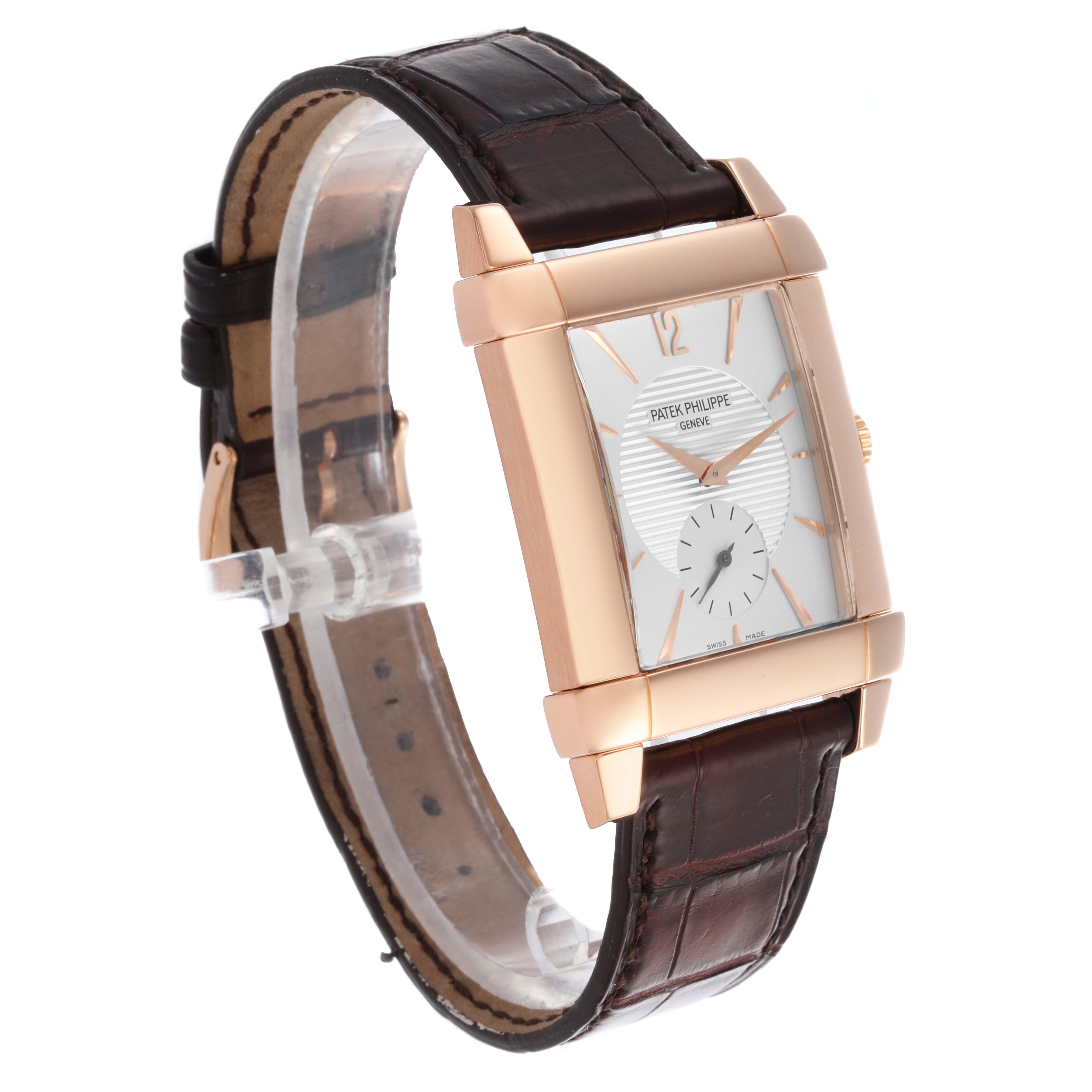 The Patek Philippe Gondolo 5111R-001 Men's Rose Gold Silver Dial 5111R-001 Men's Rose Gold Silver Dial watch is shown at a slight angle, displaying its rectangular face, gold case, and leather strap.