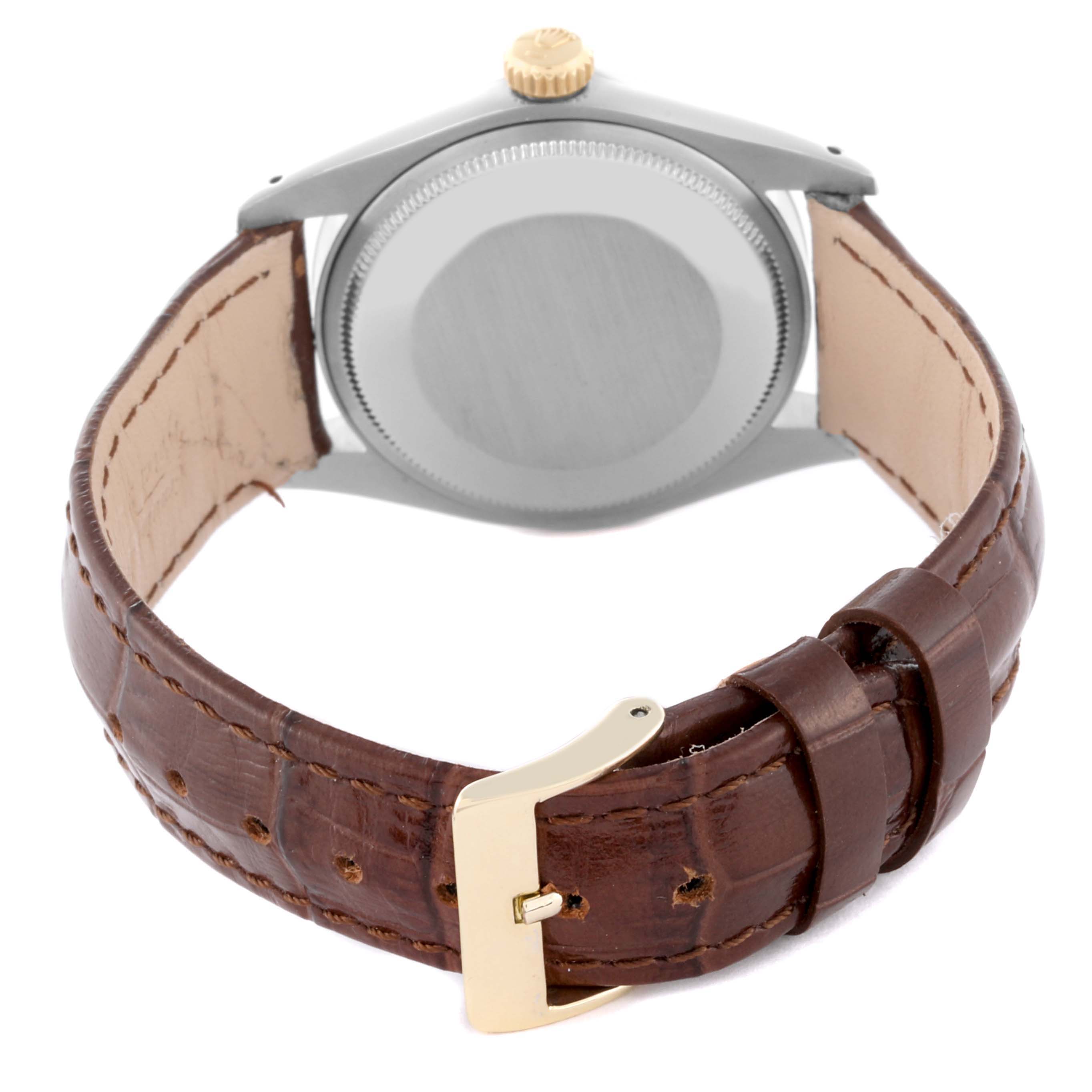 The Rolex Vintage Collection 5701 Men's Steel and Gold (two tone) Silver Dial 5701 Men's Steel and Gold (two tone) Silver Dial watch is shown from the back, highlighting the case, crown, and brown leather strap with a buckle.