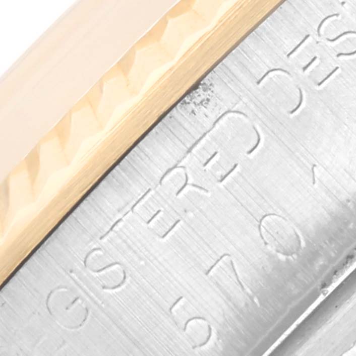 The image shows a close-up of the engraved side and bezel of a Rolex Vintage Collection 5701 Men's Steel and Gold (two tone) Silver Dial 5701 Men's Steel and Gold (two tone) Silver Dial watch.