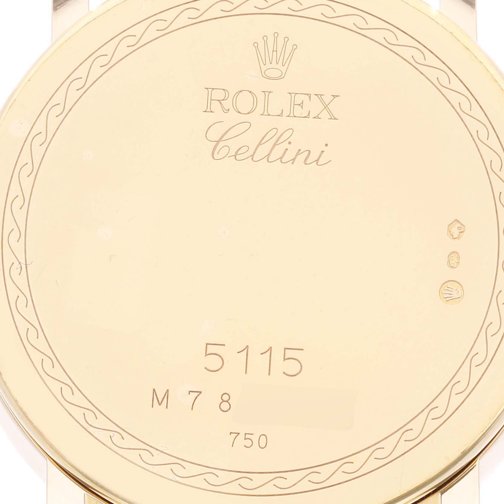 The image shows the back case of a Rolex Cellini 5115 Men's Yellow Gold Silver Dial 5115 Men's Yellow Gold Silver Dial watch, displaying engravings, including the model number 5115 and hallmark markings.