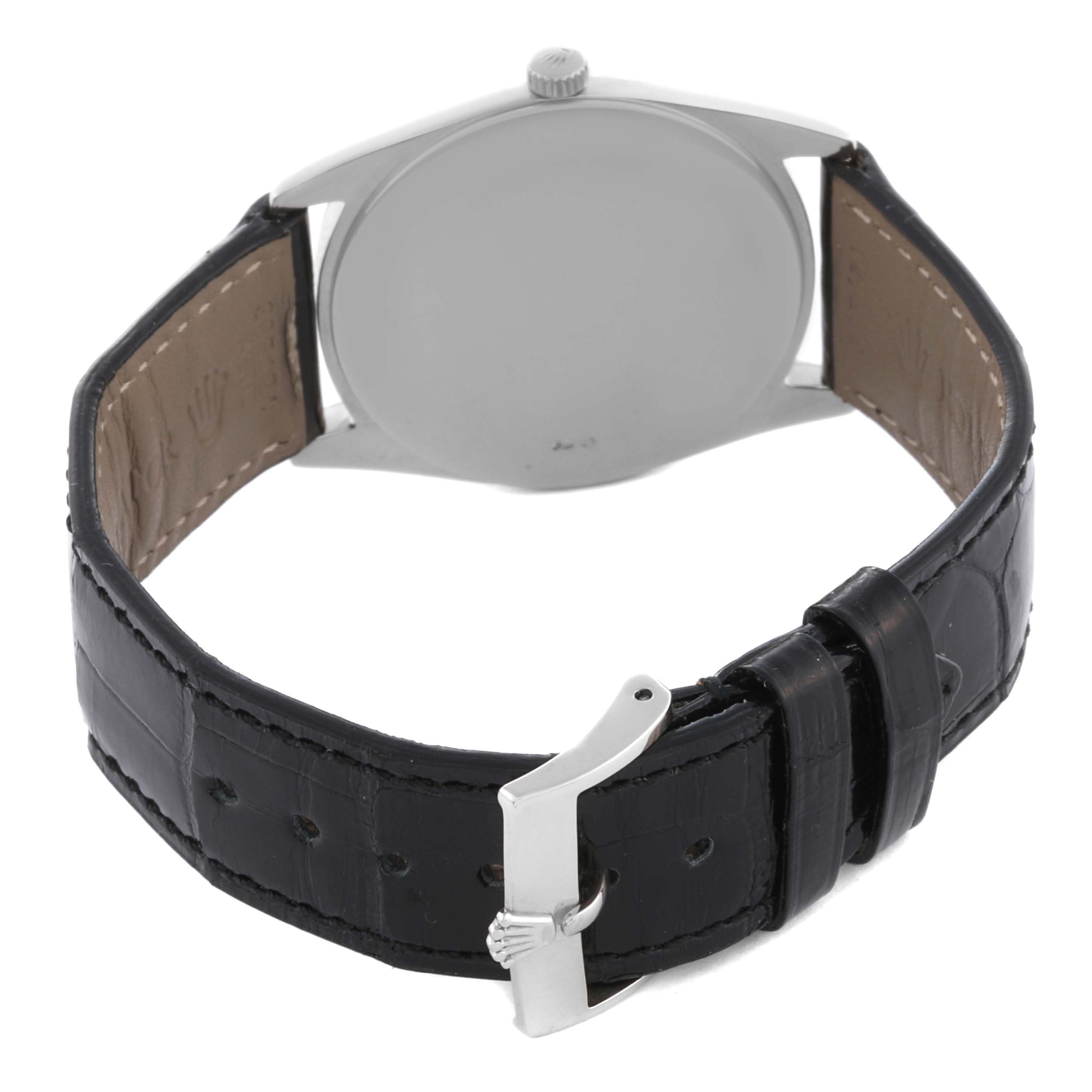 The Rolex Cellini 4233 Men's White Gold White Dial 4233 Men's White Gold White Dial watch is shown from the back, highlighting the leather strap and clasp.