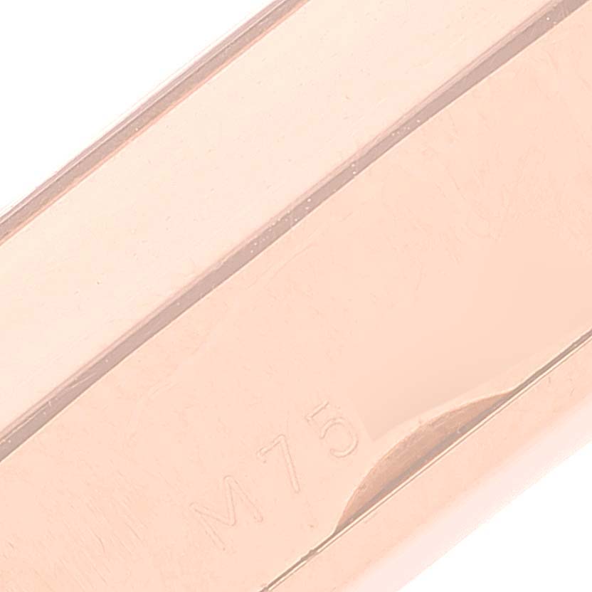 This image shows a close-up of the clasp mechanism on a Rolex Cellini 5442 Men's Rose Gold Black Dial 5442 Men's Rose Gold Black Dial model watch, showcasing the "M75" engraving.