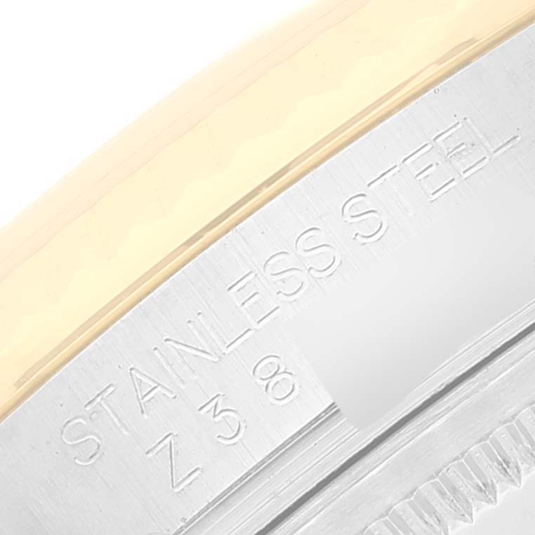 The image shows a close-up view of the engraved text on the case back edge of a Rolex Datejust 116233 Men's Steel and Gold (two tone) Champagne Dial 116233 Men's Steel and Gold (two tone) Champagne Dial watch, partially displaying "STAINLESS STEEL."