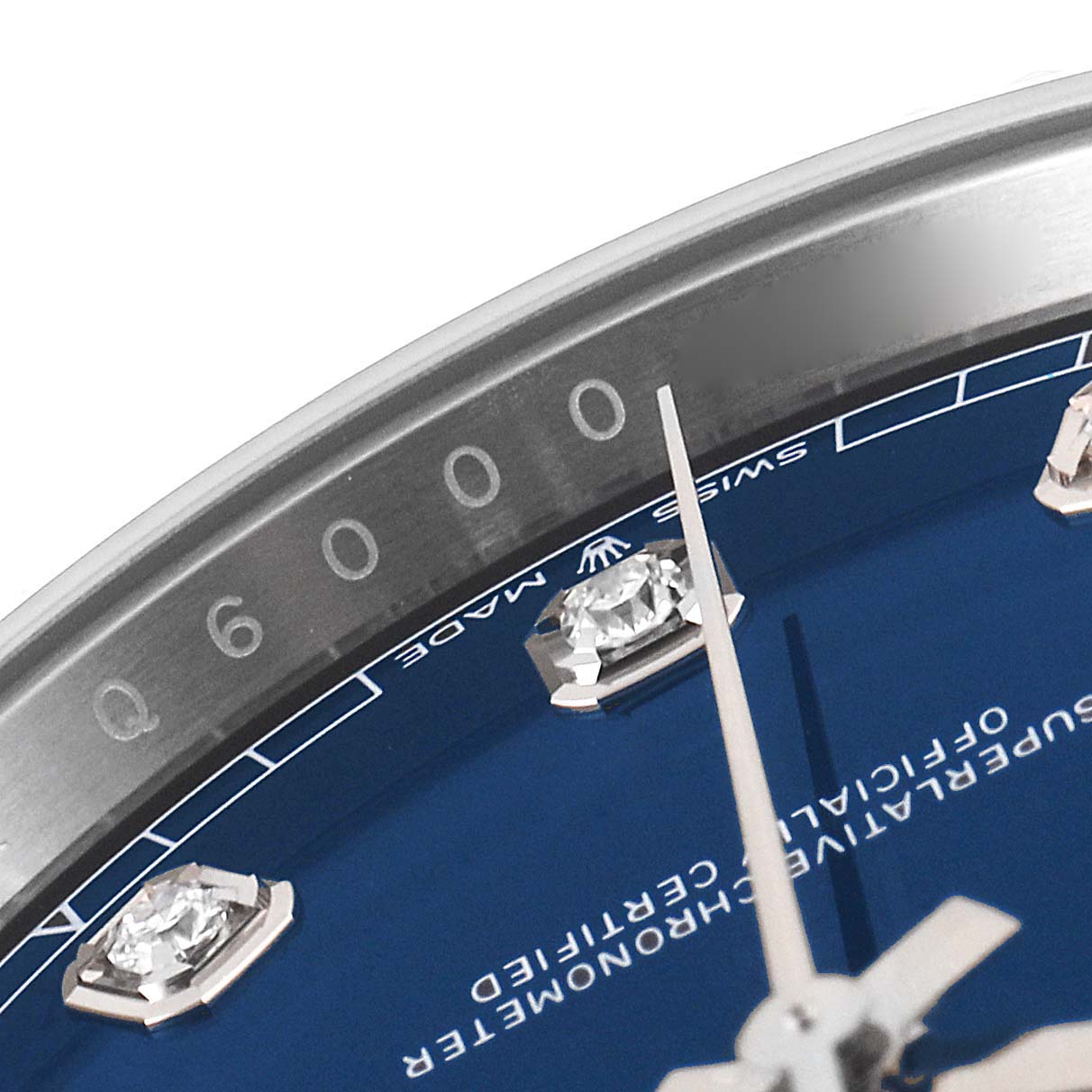 This close-up image of the Rolex Datejust 41 126334 Men
s Stainless Steel Blue Dial 126334 Men
s Stainless Steel Blue Dial watch showcases the bezel, a portion of the blue dial, and diamond hour markers.