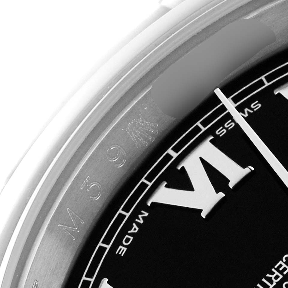 This close-up of a Rolex Datejust 116200 Men's Stainless Steel Black Dial 116200 Men's Stainless Steel Black Dial watch shows part of the dial, chapter ring, and bezel.