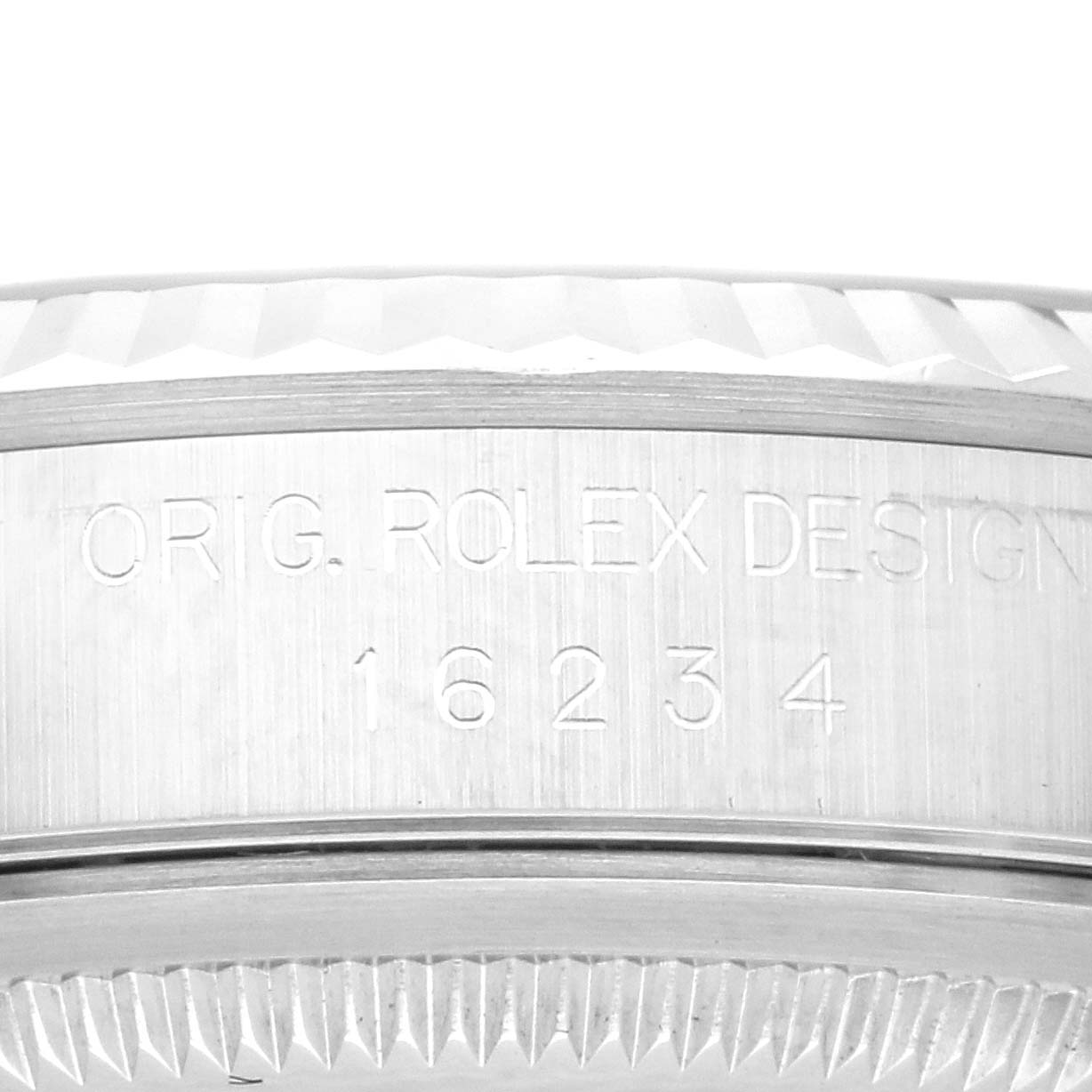 The image shows the side of a Rolex Datejust 16234G Men's Stainless Steel Blue Dial 16234G Men's Stainless Steel Blue Dial watch case with engraved model details.