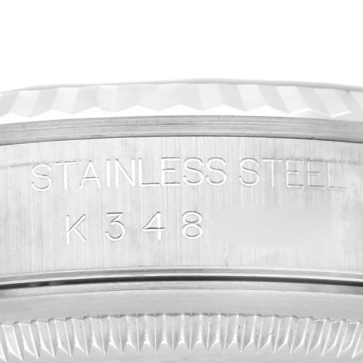 This close-up image shows the engraved side of the stainless steel bezel on the Rolex Datejust 16234G Men's Stainless Steel Blue Dial 16234G Men's Stainless Steel Blue Dial.