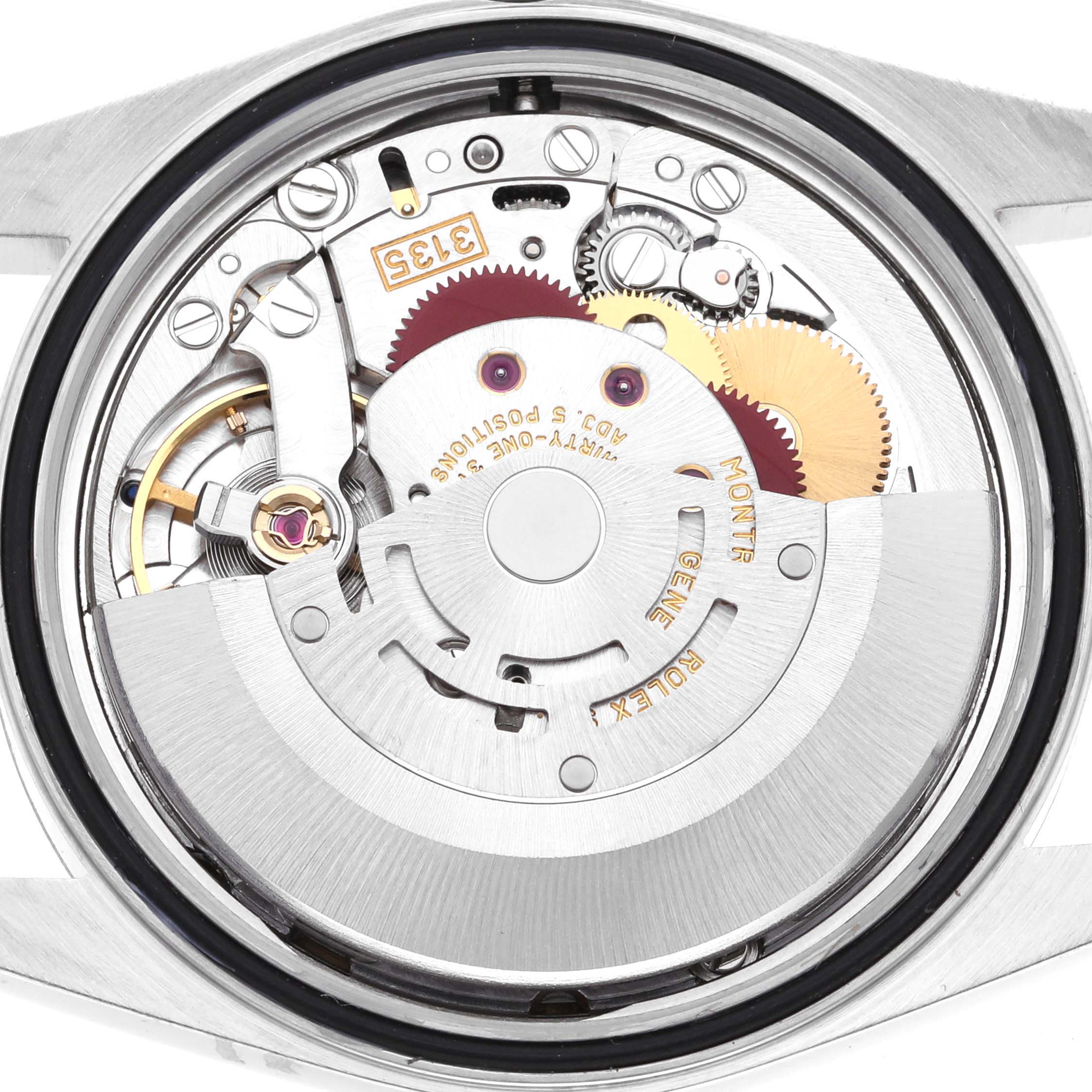 The image shows the movement of a Rolex Datejust 16234G Men's Stainless Steel Blue Dial 16234G Men's Stainless Steel Blue Dial, highlighting gears and the rotor from the back view.