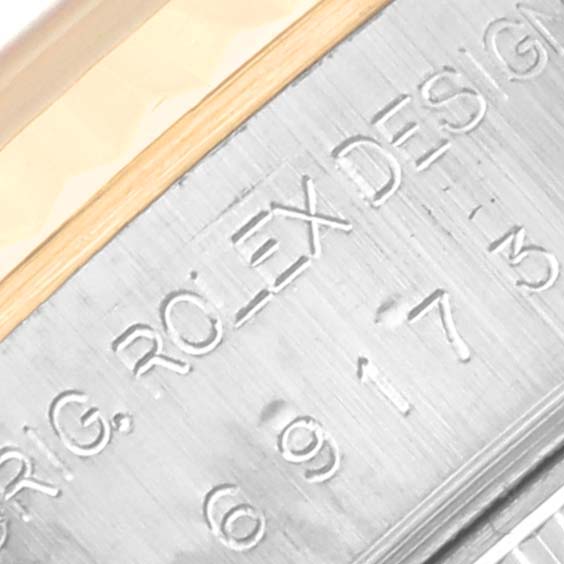 This image shows a close-up of the side engraving on the bezel of a Rolex Datejust 69173 Women's Steel and Gold (two tone) White Dial 69173 Women's Steel and Gold (two tone) White Dial watch.