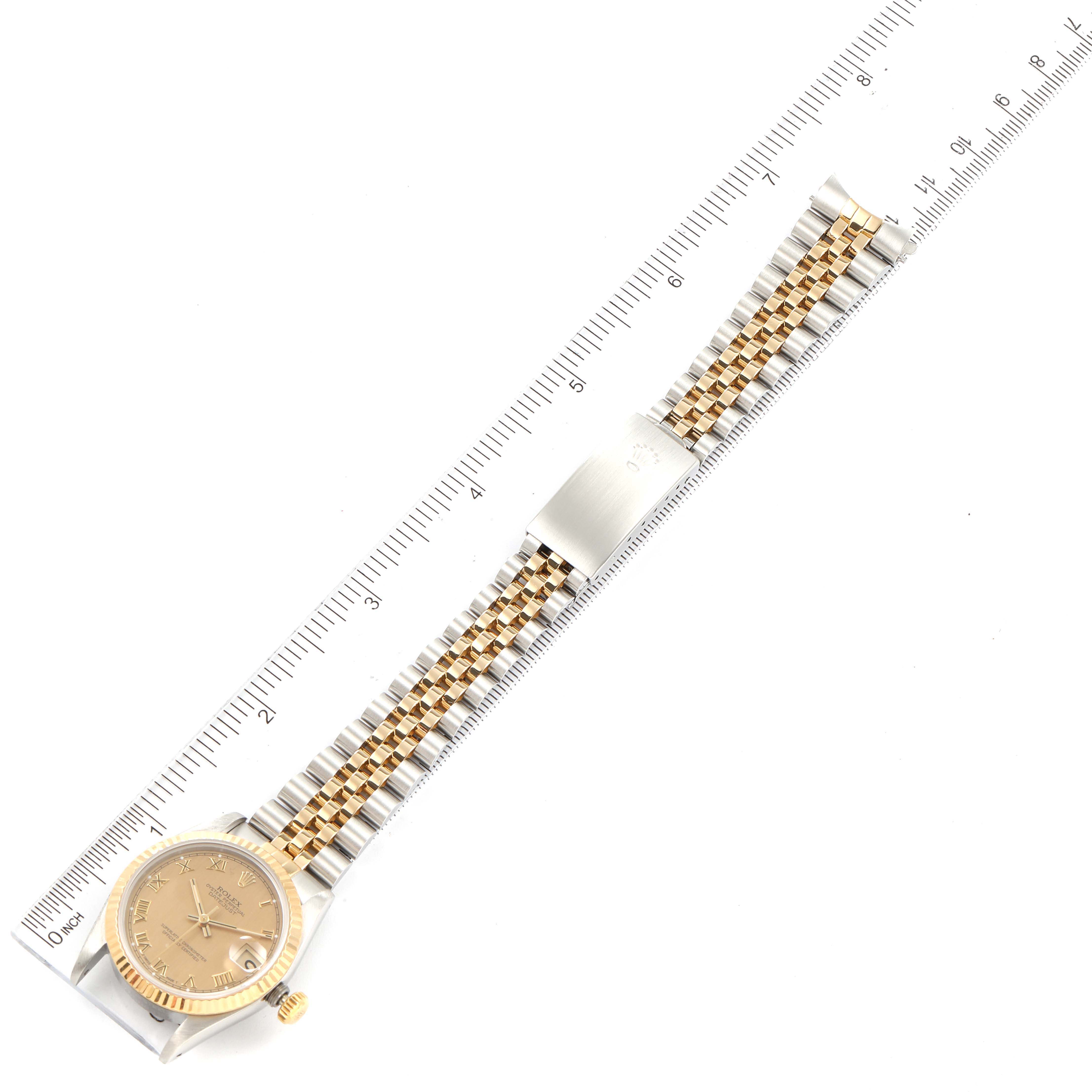 The Rolex Mid-Size 68273 Women's Steel and Gold (two tone) Champagne Dial 68273 Women's Steel and Gold (two tone) Champagne Dial model watch is shown laid flat with the entire strap and face visible, positioned against a ruler.