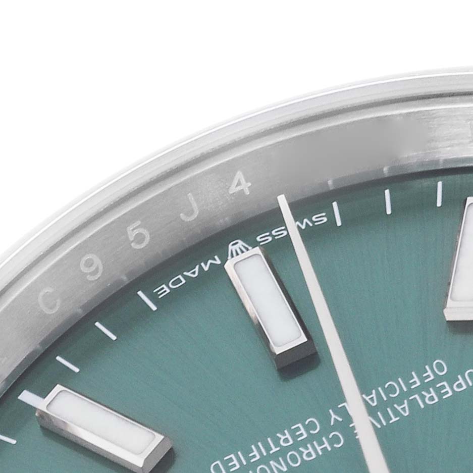 This image shows a close-up of the Rolex Datejust 126200 Men's Stainless Steel Green Dial 126200 Men's Stainless Steel Green Dial model, highlighting the dial, indices, and part of the bezel.