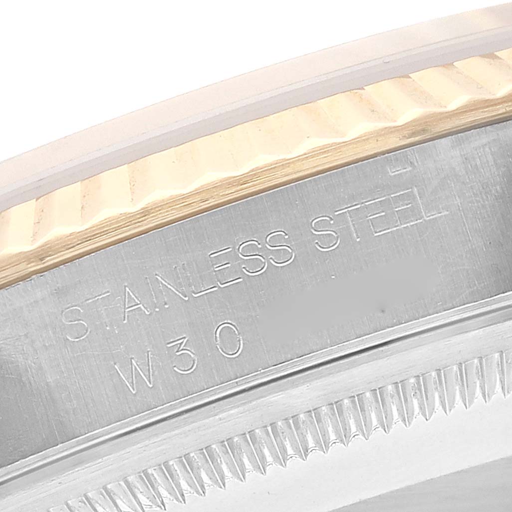 This close-up image features the engraved stainless steel bezel and fluted edge of the Rolex Datejust 16233 Men's Steel and Gold (two tone) Champagne Dial 16233 Men's Steel and Gold (two tone) Champagne Dial watch model.