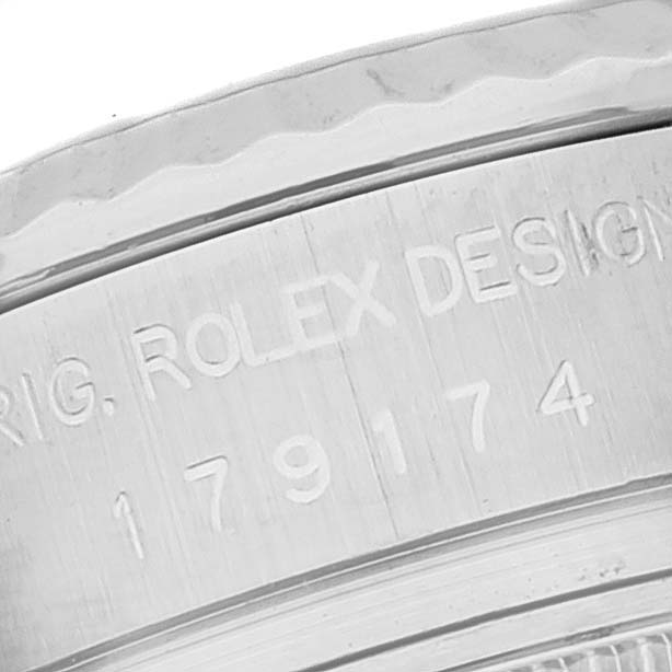 This close-up image shows the engraved serial number and branding inside the bezel of a Rolex Datejust 179174 Women's Stainless Steel Mother of Pearl Dial 179174 Women's Stainless Steel Mother of Pearl Dial watch.