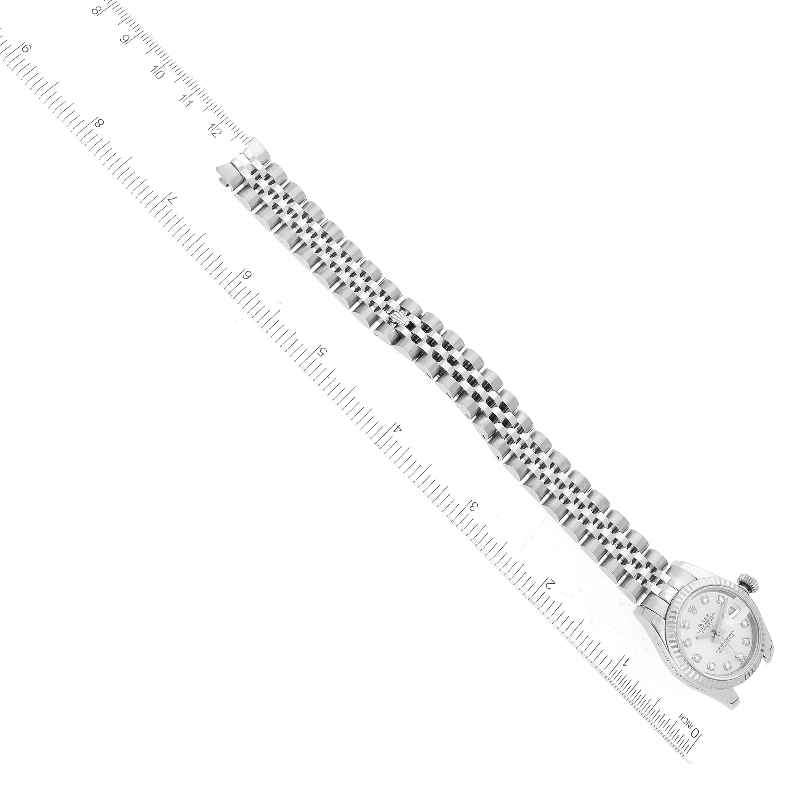 The Rolex Datejust 179174 Women's Stainless Steel Silver Dial 179174 Women's Stainless Steel Silver Dial watch is shown from above, displaying its face and full bracelet alongside a ruler for size reference.