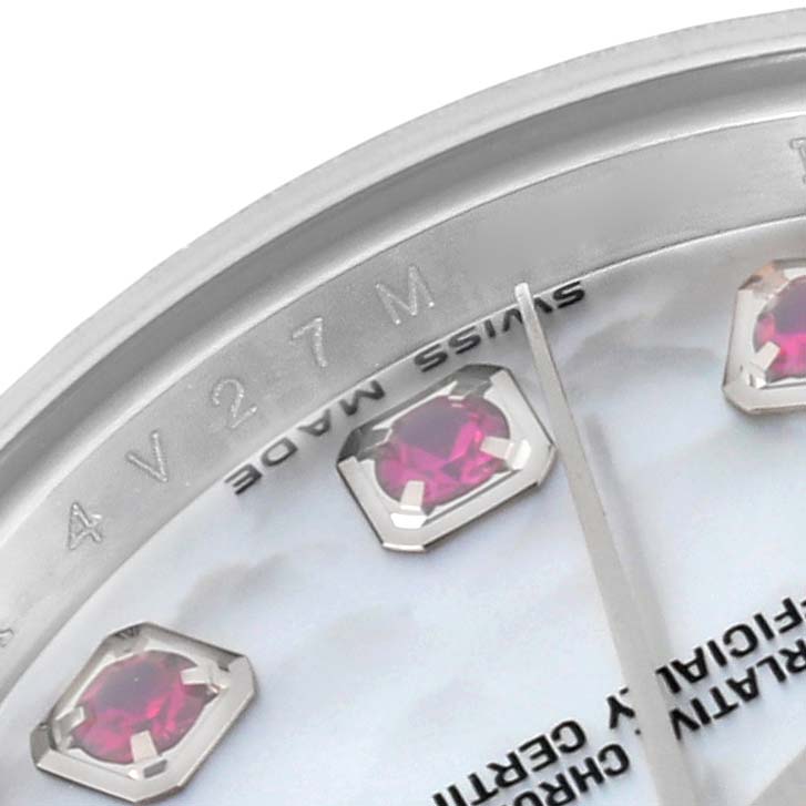 This close-up angle of a Rolex Datejust 179174 Women's Stainless Steel Mother of Pearl Dial 179174 Women's Stainless Steel Mother of Pearl Dial watch displays part of the dial with ruby hour markers and the label "SWISS MADE."