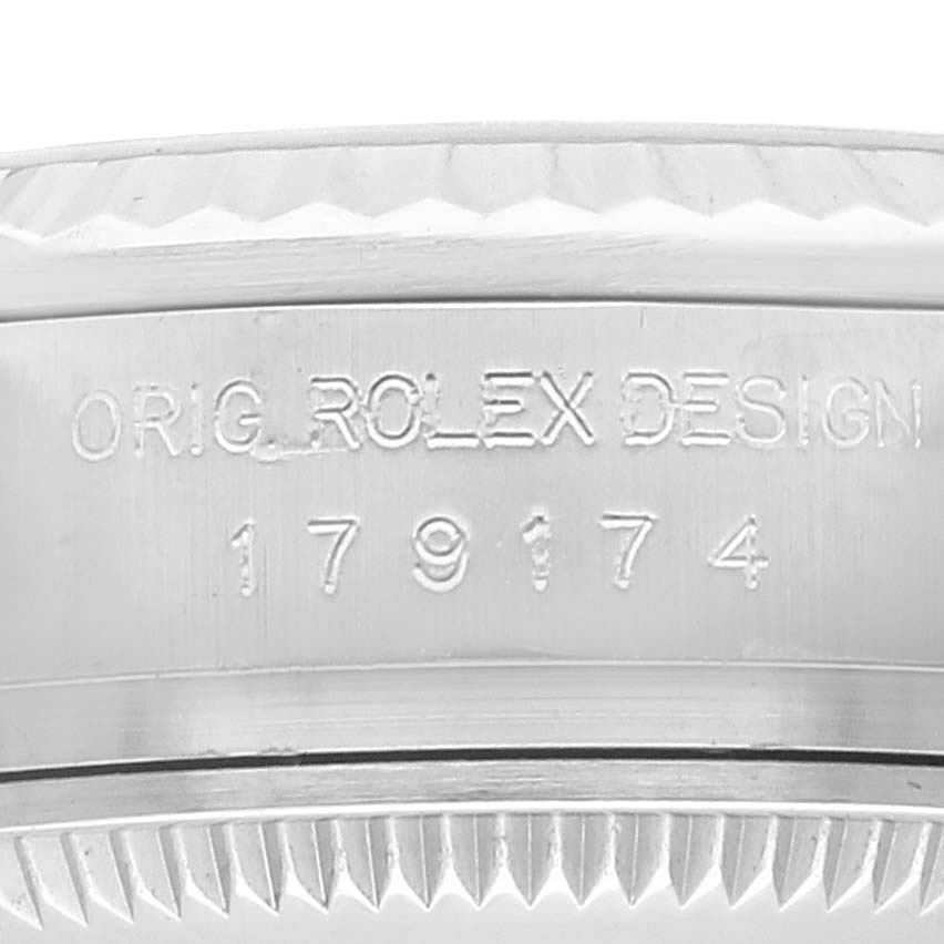 This image shows the side profile of the bezel and case of a Rolex Datejust 179174 Women's Stainless Steel Mother of Pearl Dial 179174 Women's Stainless Steel Mother of Pearl Dial watch, displaying its serial number and "ORIG. ROLEX DESIGN."