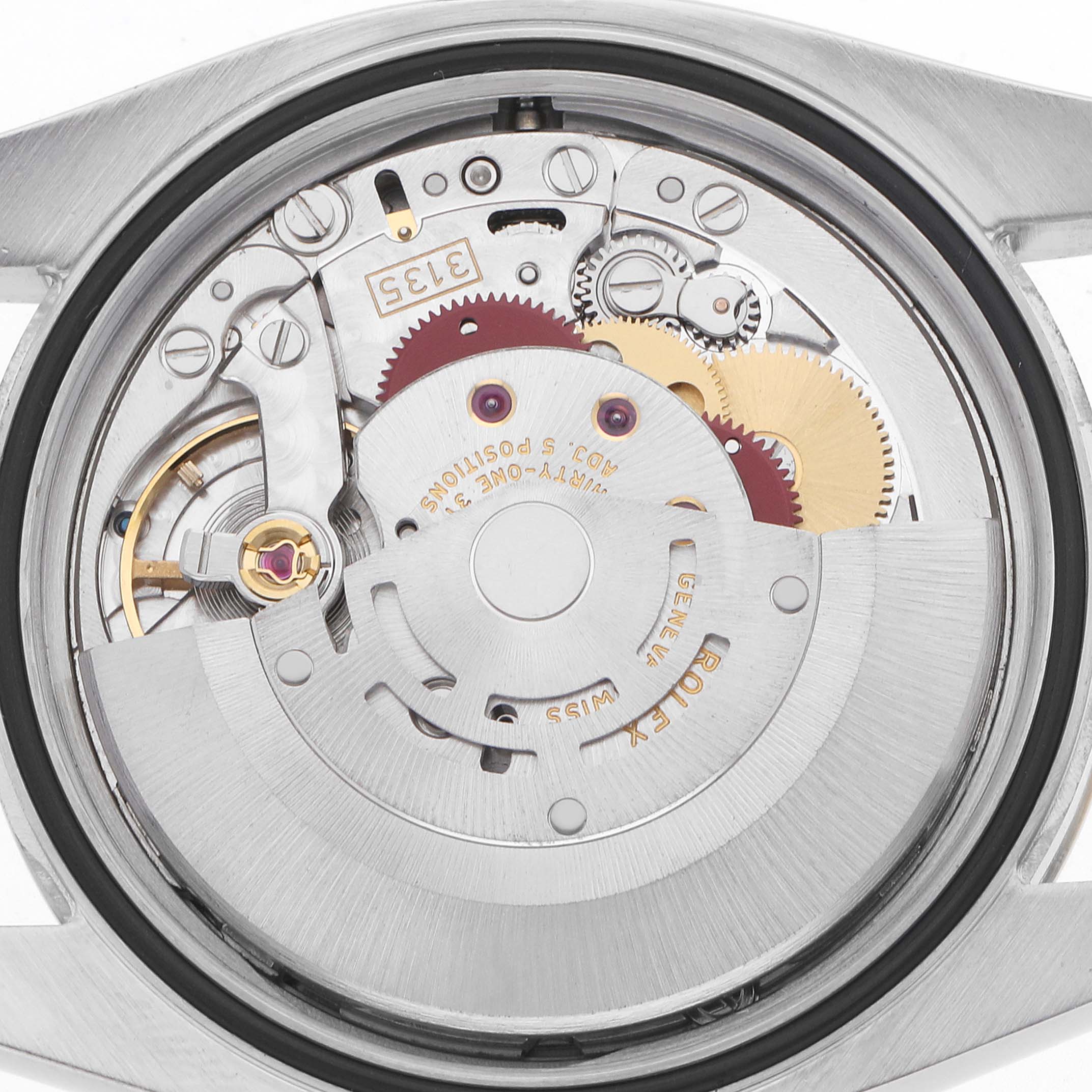 The image shows the movement of a Rolex Datejust 116233 Men
s Steel and Gold (two tone) Champagne Dial watch, viewed from the back, highlighting gears and components.