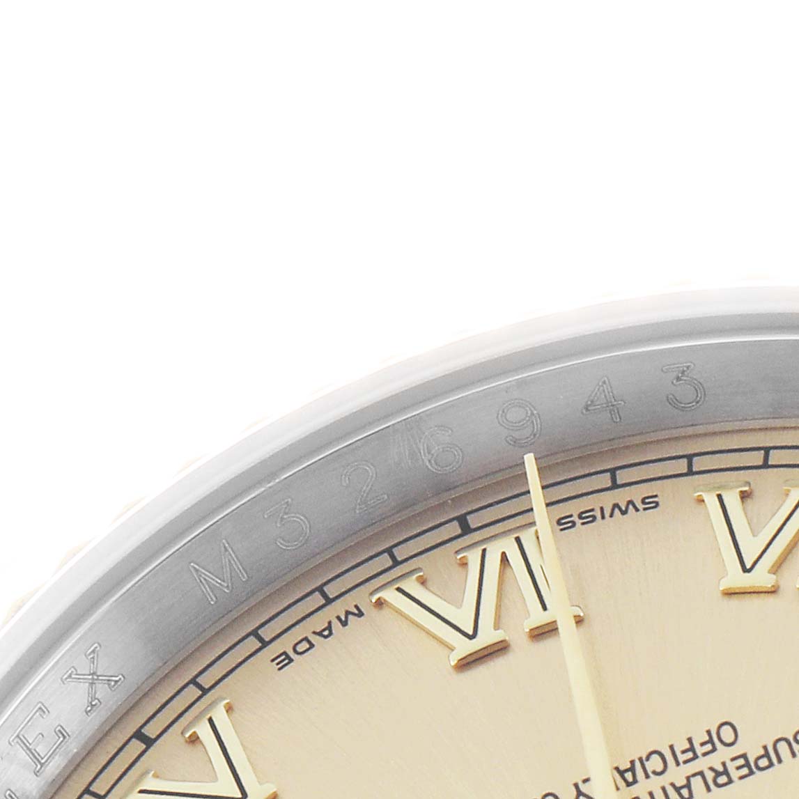 The image shows a close-up of the Rolex Datejust 116233 Men
s Steel and Gold (two tone) Champagne Dial
s bezel with engraved numbers and part of the dial featuring Roman numerals.