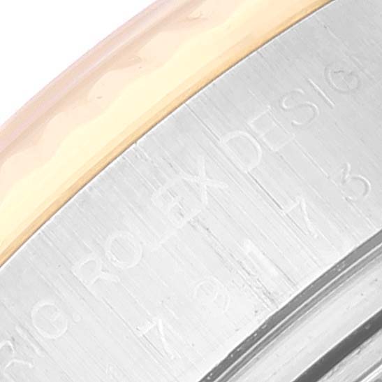 This is a close-up of the side of a Rolex Datejust 179173 Women's Steel and Gold (two tone) Champagne Dial 179173 Women's Steel and Gold (two tone) Champagne Dial, showing part of the bezel and the engraved brand name.