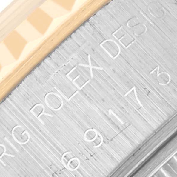 The image shows an angled view of the engraved side of the Rolex Datejust 69173 Women's Steel and Gold (two tone) Champagne Dial 69173 Women's Steel and Gold (two tone) Champagne Dial watch case, highlighting the branding and serial numbers.