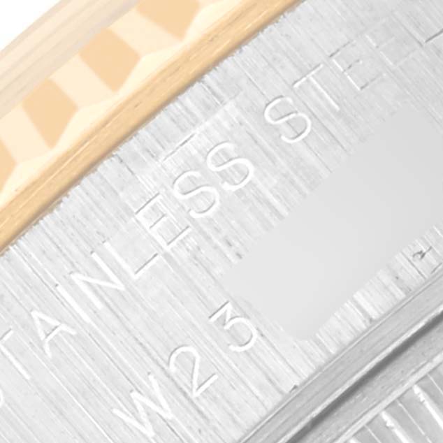 The image shows a close-up of the Rolex Datejust 69173 Women's Steel and Gold (two tone) Champagne Dial 69173 Women's Steel and Gold (two tone) Champagne Dial's fluted bezel and the engraved "Stainless Steel" text on the rehaut.