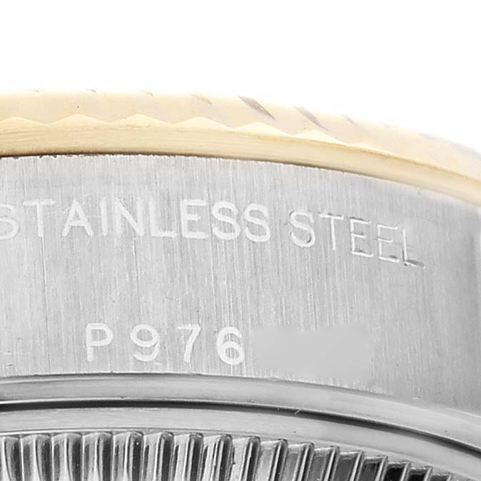 The image shows a side angle of the Rolex Datejust 79173 Women's Steel and Gold (two tone) Champagne Dial 79173 Women's Steel and Gold (two tone) Champagne Dial's case, focusing on the stainless steel engraving and fluted bezel.