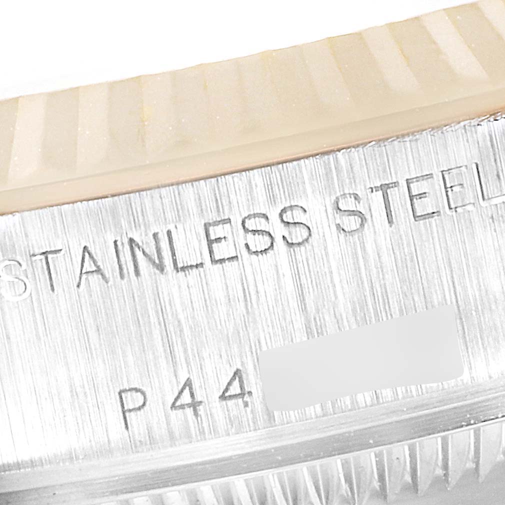 This close-up image shows the side of a stainless steel Rolex Datejust 79173 Women's Steel and Gold (two tone) Champagne Dial 79173 Women's Steel and Gold (two tone) Champagne Dial watch case with part of the bezel and engravings visible.