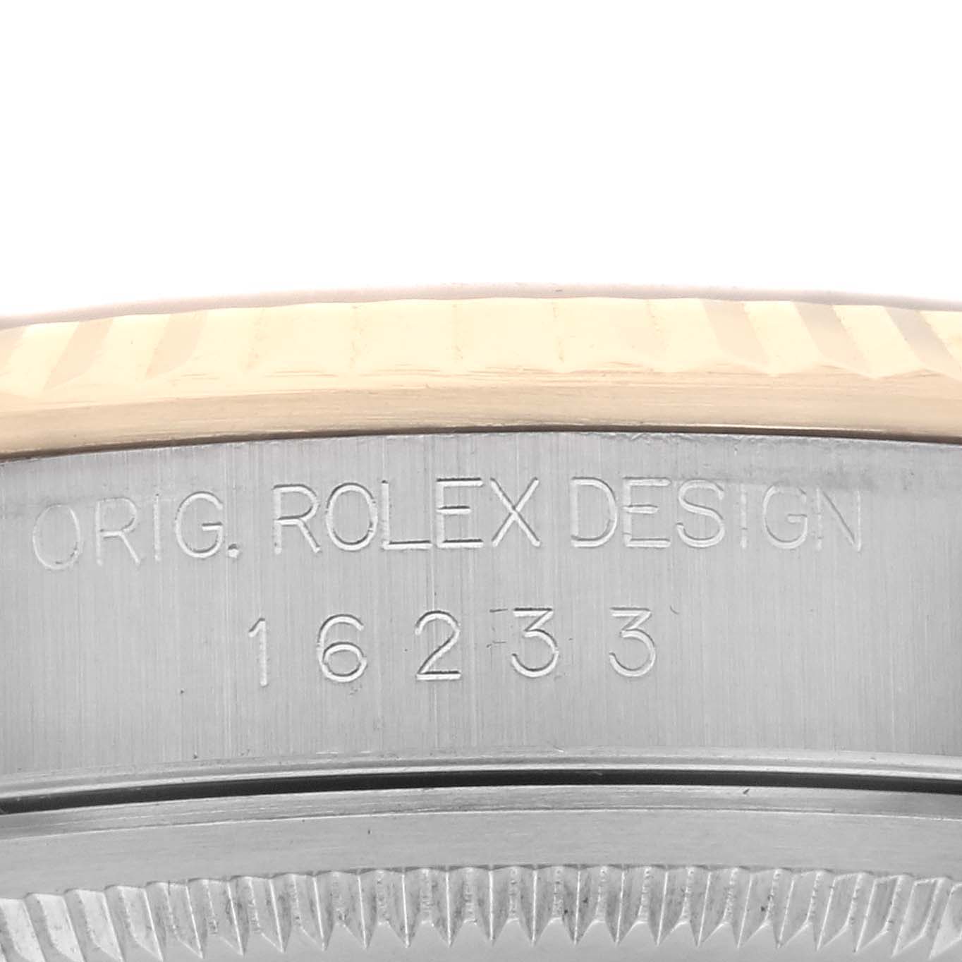 The image shows the side of a Rolex Datejust 16233 Men's Steel and Gold (two tone) Champagne Dial 16233 Men's Steel and Gold (two tone) Champagne Dial, revealing the engraved model number and "ORIG. ROLEX DESIGN".
