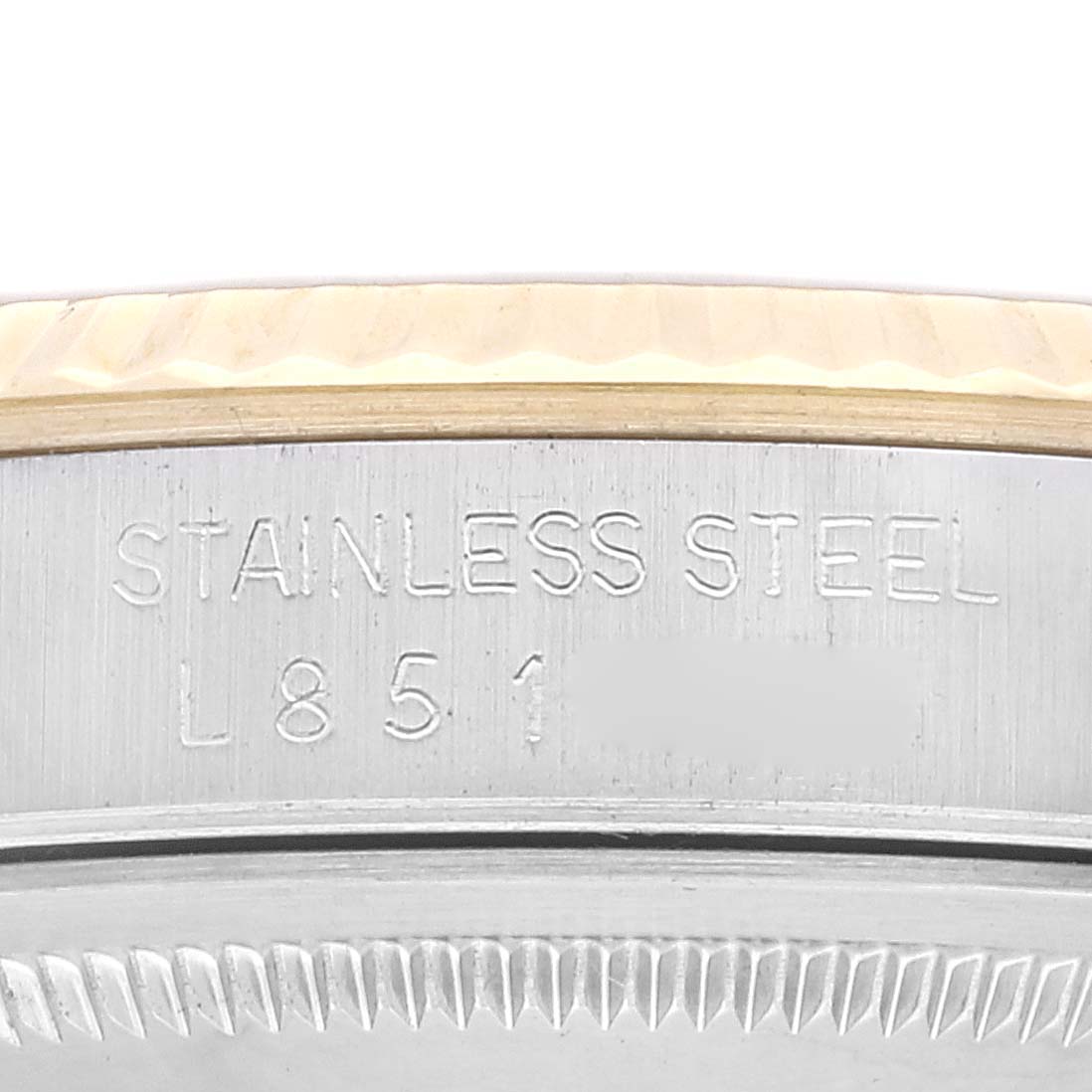 This image shows a close-up of the engraved text and fluted bezel on a Rolex Datejust 16233 Men's Steel and Gold (two tone) Champagne Dial 16233 Men's Steel and Gold (two tone) Champagne Dial watch.