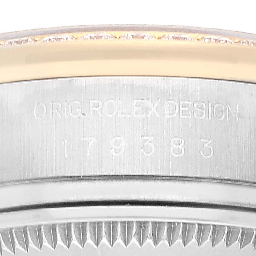 This is a close-up image showing the serial number and engraving on the edge of the case of a Rolex Datejust 179383 Women's Steel and Gold (two tone) Mother of Pearl Dial 179383 Women's Steel and Gold (two tone) Mother of Pearl Dial watch.