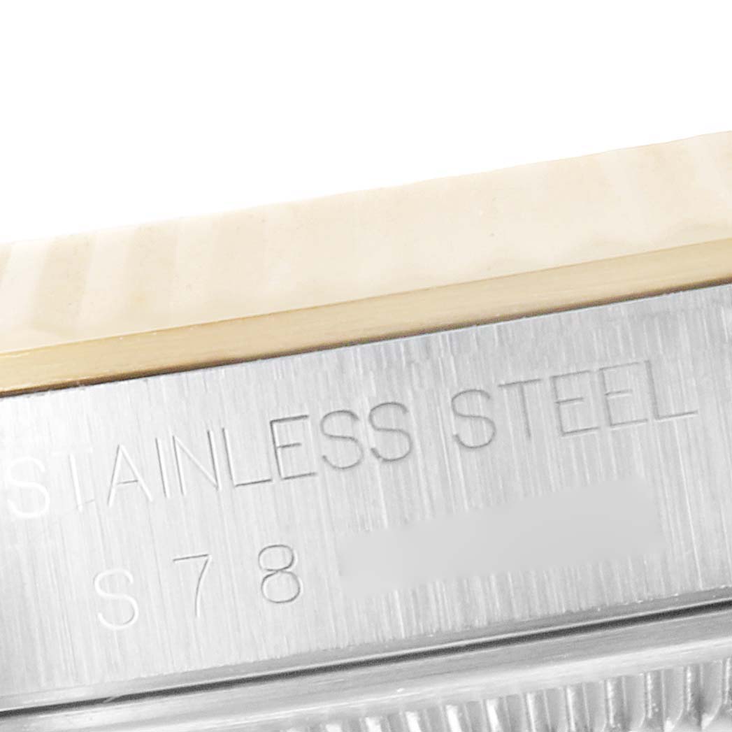 This close-up angle of the Rolex Datejust 16233 Men's Steel and Gold (two tone) Beige Dial 16233 Men's Steel and Gold (two tone) Beige Dial watch shows the stainless steel case with part of the serial number.