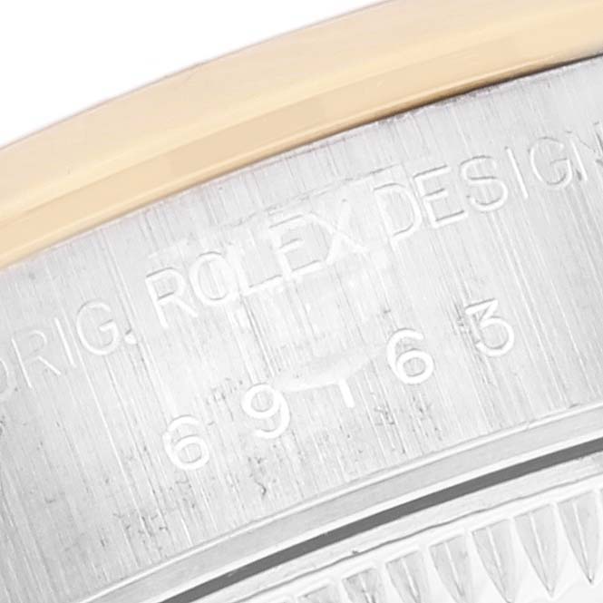 This close-up image shows the serial number and part of the case of a Rolex Datejust 69163 Women's Steel and Gold (two tone) Grey Dial 69163 Women's Steel and Gold (two tone) Grey Dial watch.