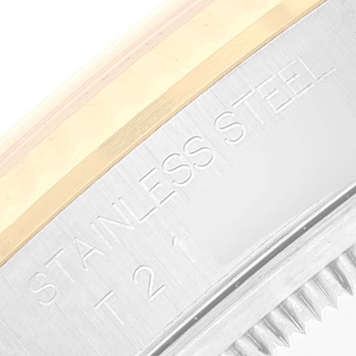 This image shows a close-up of the engraved bezel edge and part of the case of a Rolex Datejust 16233 Men
s Steel and Gold (two tone) Grey Dial 16233 Men
s Steel and Gold (two tone) Grey Dial watch, highlighting "STAINLESS STEEL".