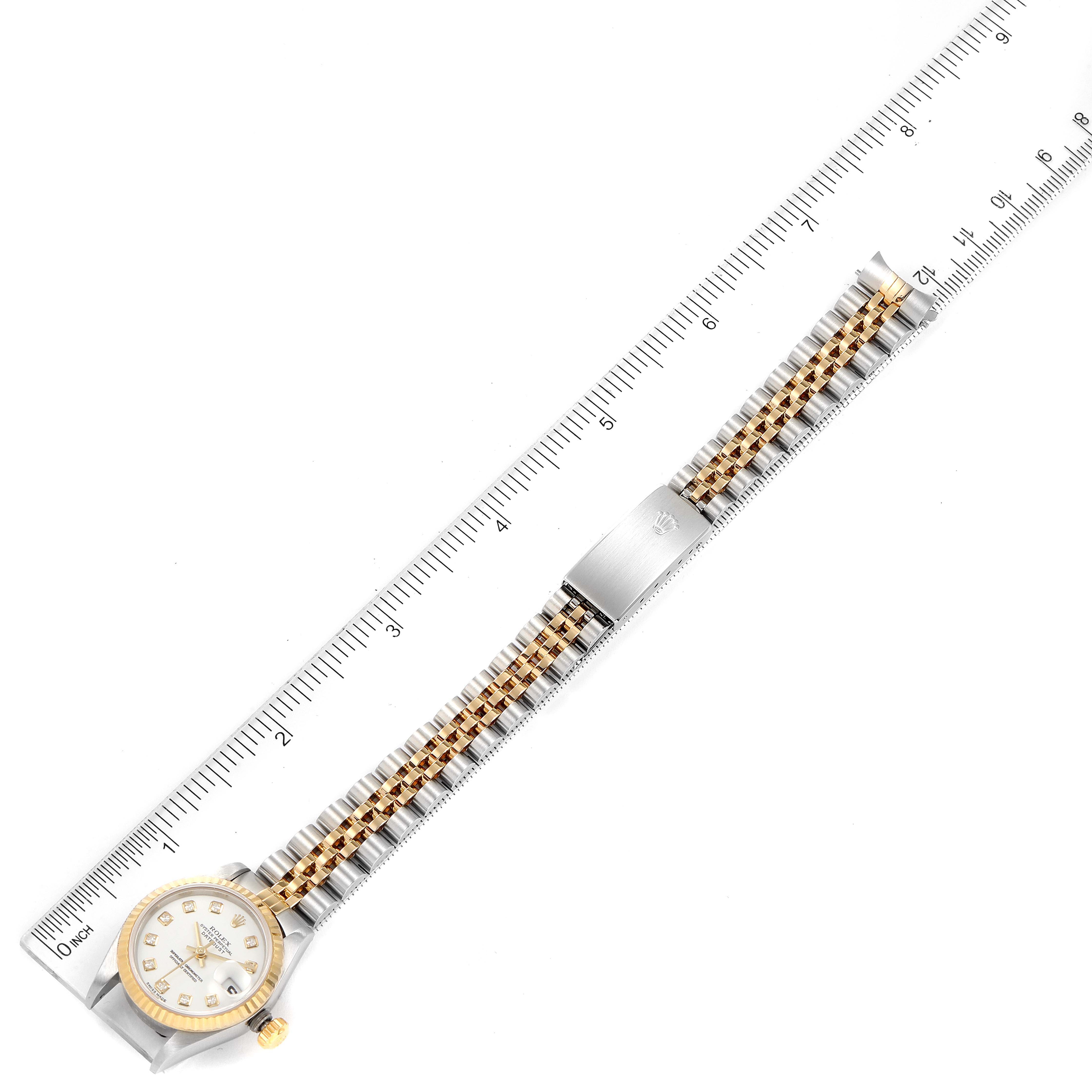 The image shows a Rolex Datejust 79173 Women's Steel and Gold (two tone) White Dial 79173 Women's Steel and Gold (two tone) White Dial watch laid flat with a ruler, displaying the entire bracelet and face.
