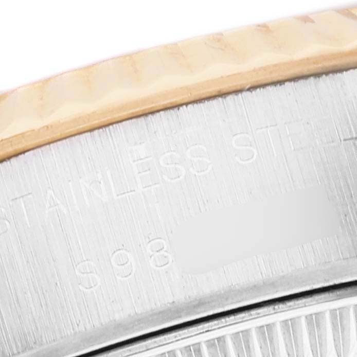 The image shows a close-up of the side and part of the bezel of a Rolex Datejust 69173 Women's Steel and Gold (two tone) White Dial 69173 Women's Steel and Gold (two tone) White Dial watch, highlighting the stainless steel engraving.