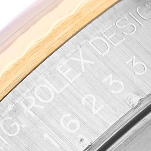 The image shows a close-up of the engraved bezel on a Rolex Datejust 16233 Men's Steel and Gold (two tone) Blue Dial 16233 Men's Steel and Gold (two tone) Blue Dial watch, highlighting part of the serial number.