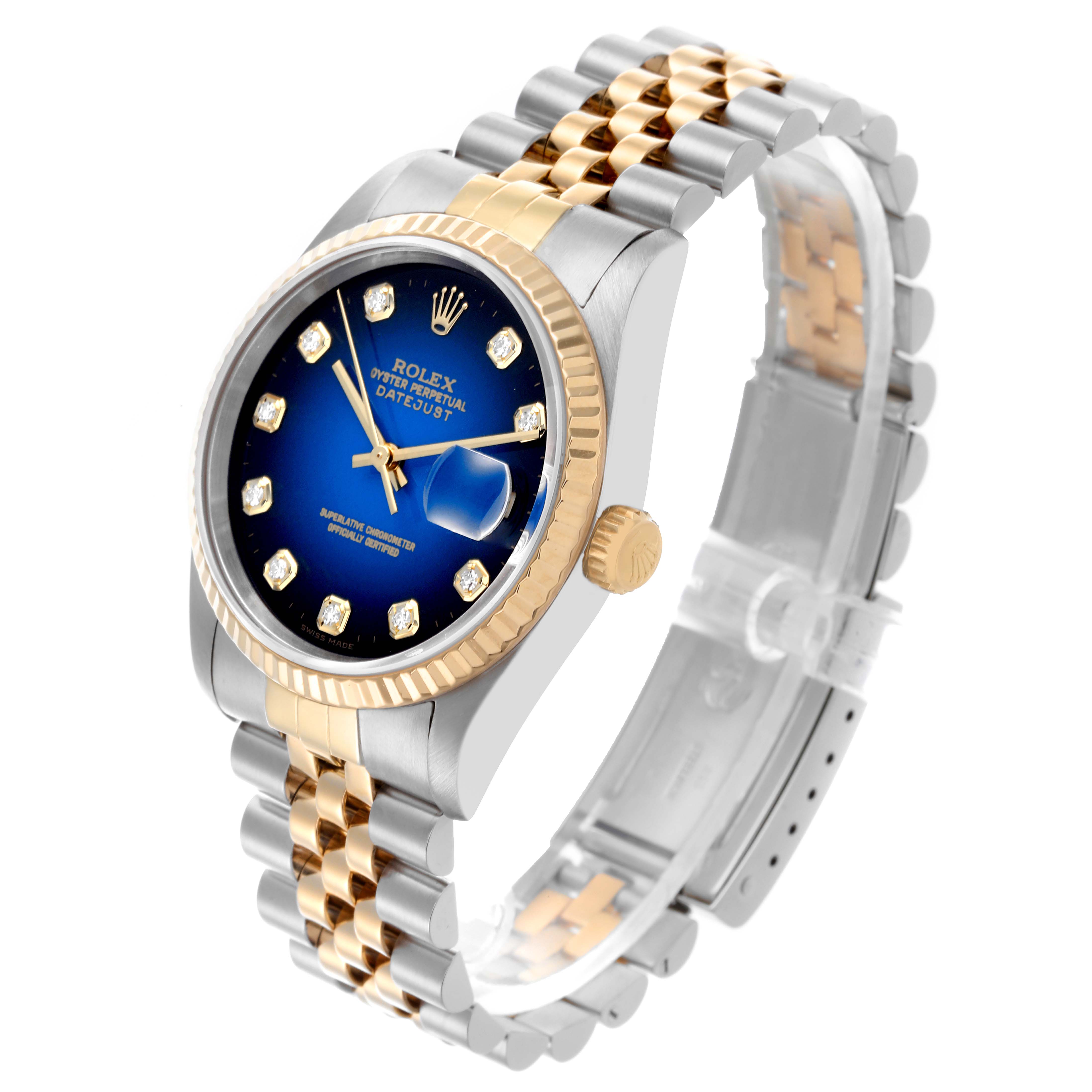 The Rolex Datejust 16233 Men's Steel and Gold (two tone) Blue Dial 16233 Men's Steel and Gold (two tone) Blue Dial watch is shown at an angled side view, highlighting the dial, bezel, bracelet, and crown.