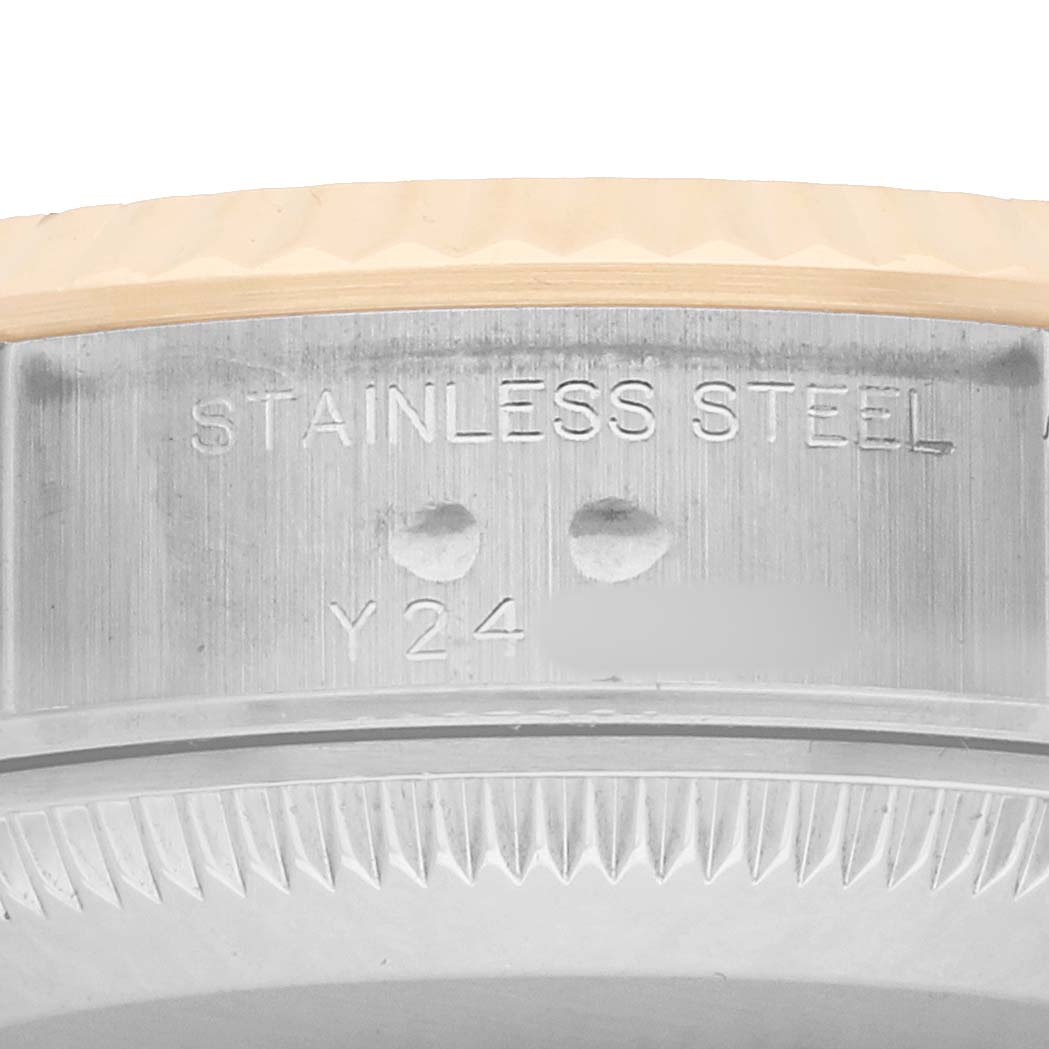 The image shows a close-up of the side detailing on the stainless steel case of a Rolex Datejust 79173 Women
s Steel and Gold (two tone) Silver Dial watch.